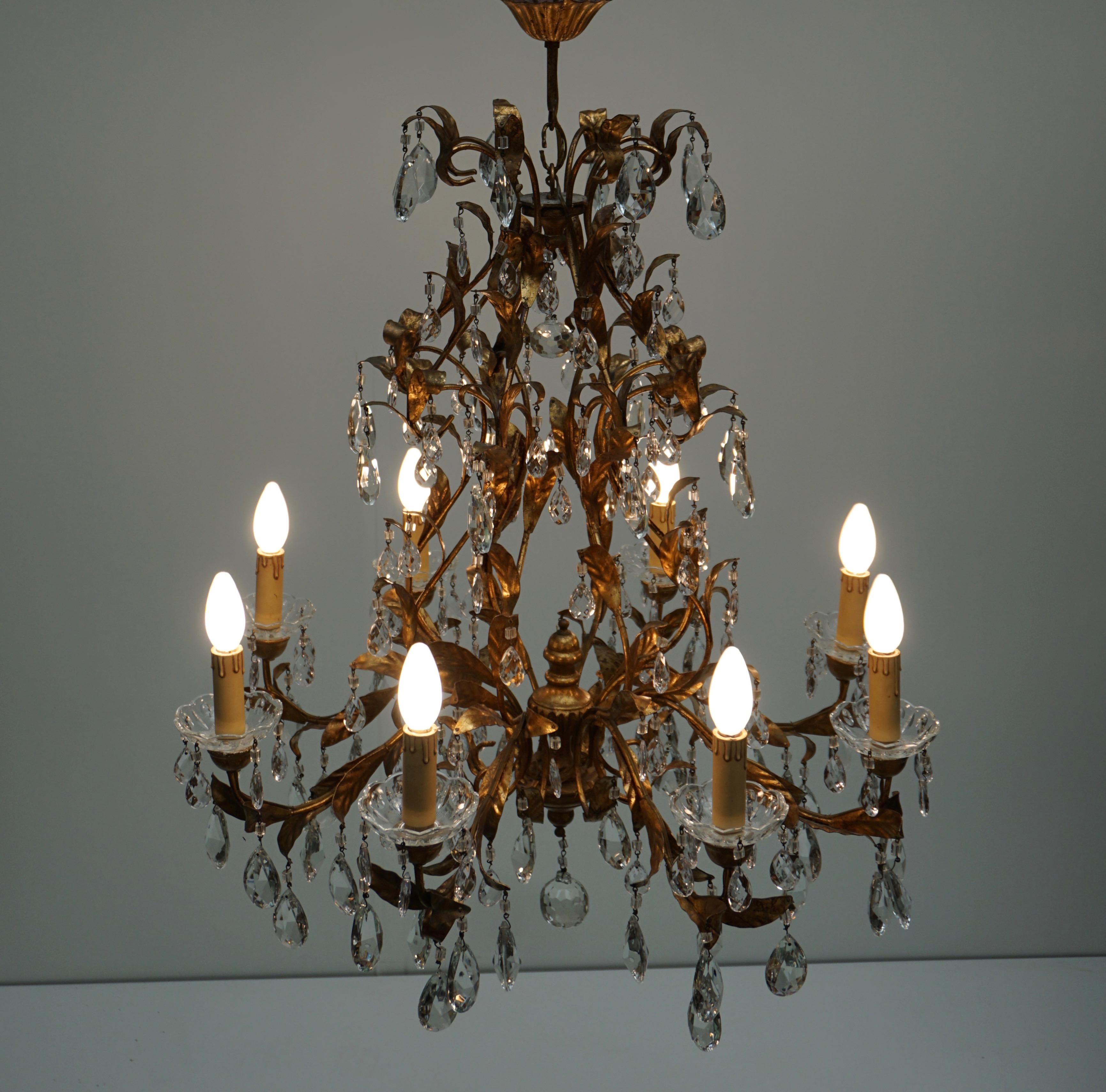 Hollywood Regency Gilded Brass Eight-Light Chandelier with Leaves and Crystal For Sale