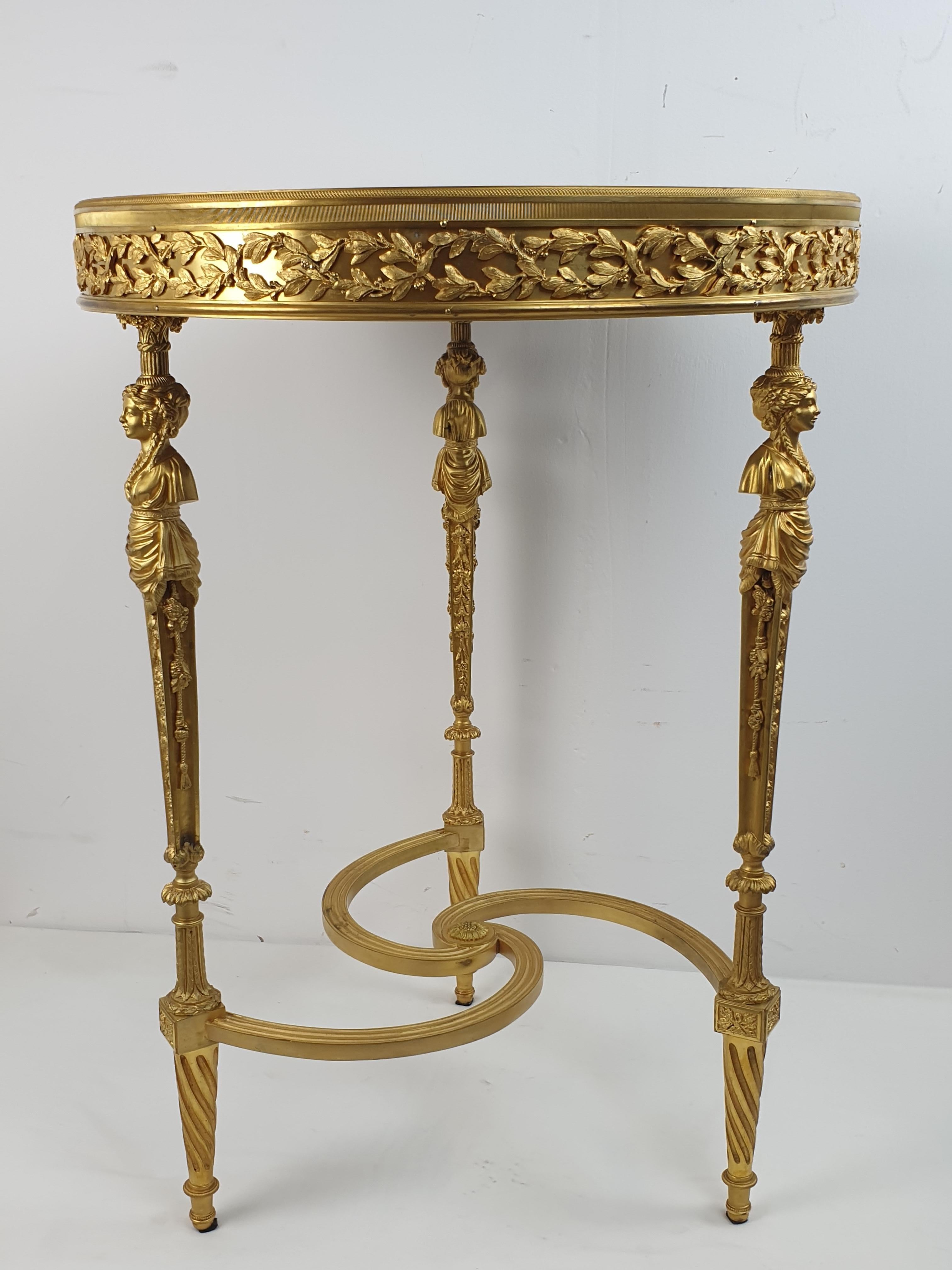 Gueridon table entirely made of gilded bronze, with a beautiful malachite top. Model attributed to Paul Sormani, late 19th century, on which indicates the shape of the brozne cariathydes. Great condition, the highest quality bronze details with an