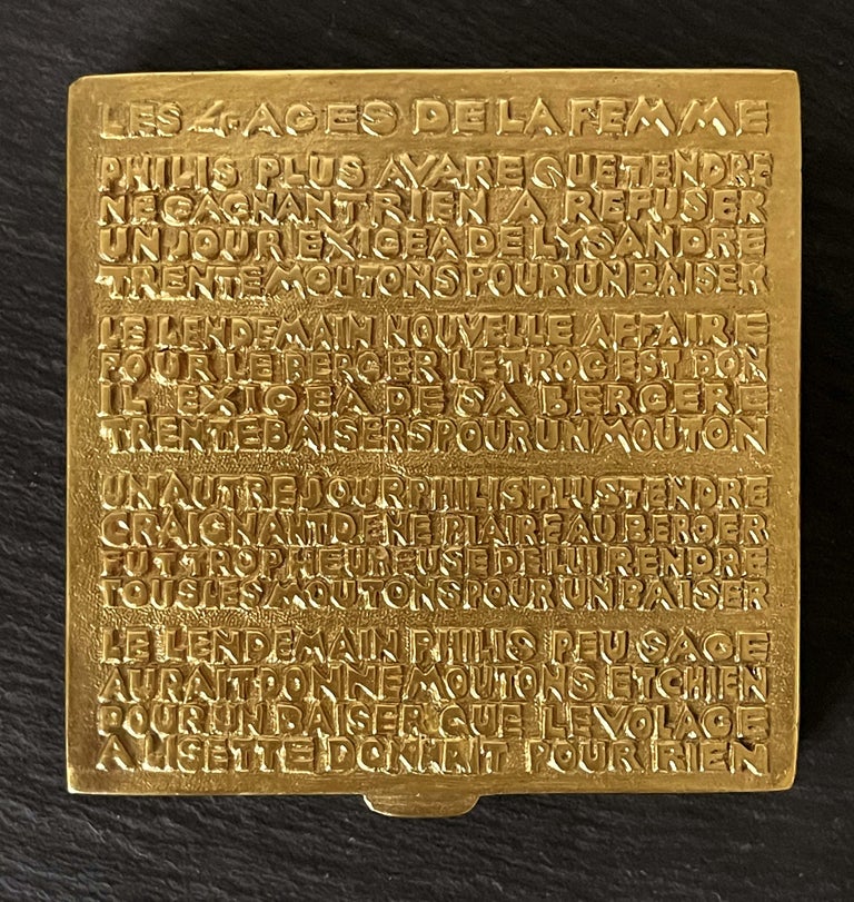 A gilt bronze poudrier box with cast poem on surface by Parisian art jeweler Line Vautrin (1913-1997) circa 1940s. The poem 
