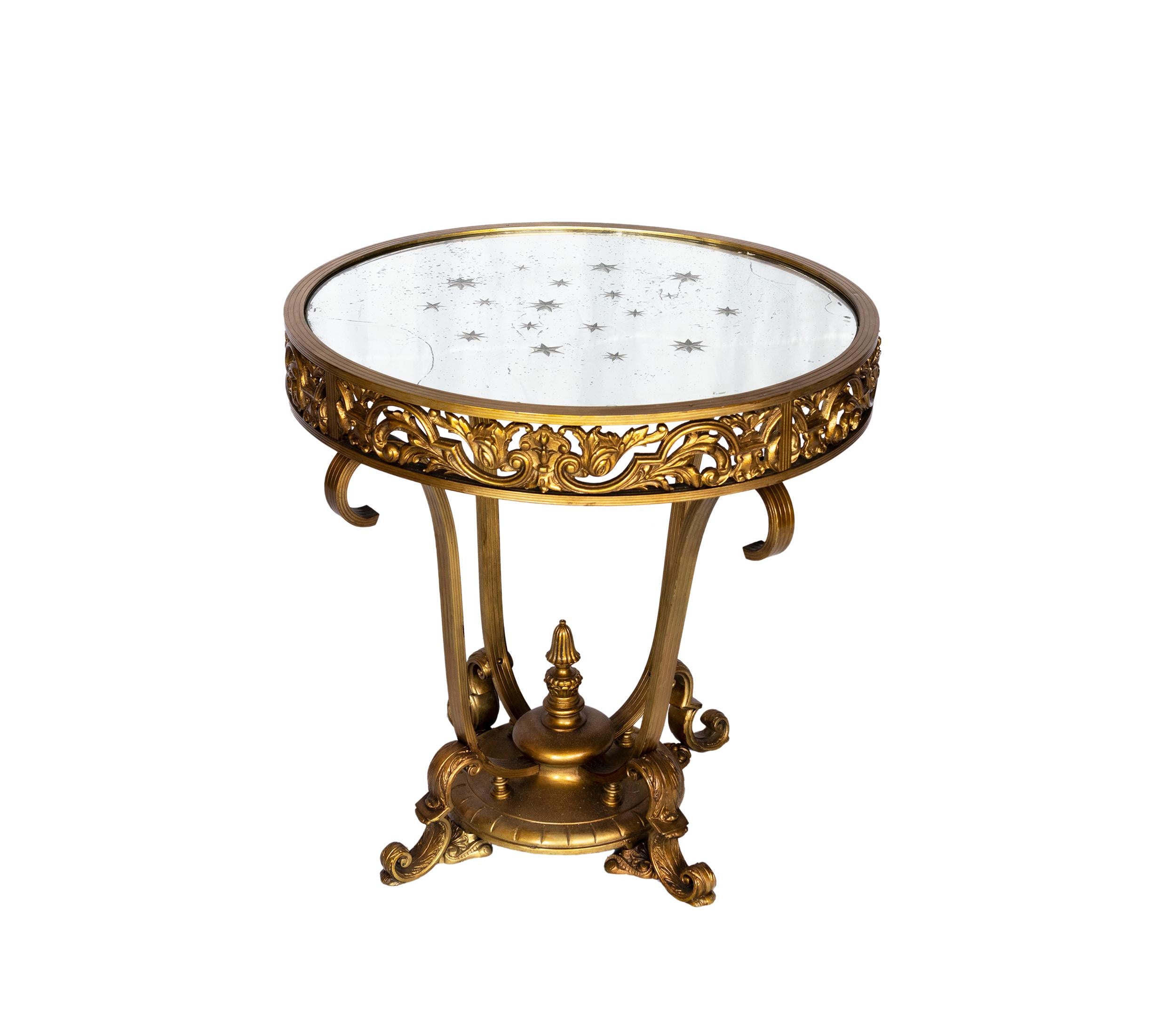 Bronze circular gold coffee table, four short legs and mirrored top with encrusted stars in a modern twist of Louis XV style.

