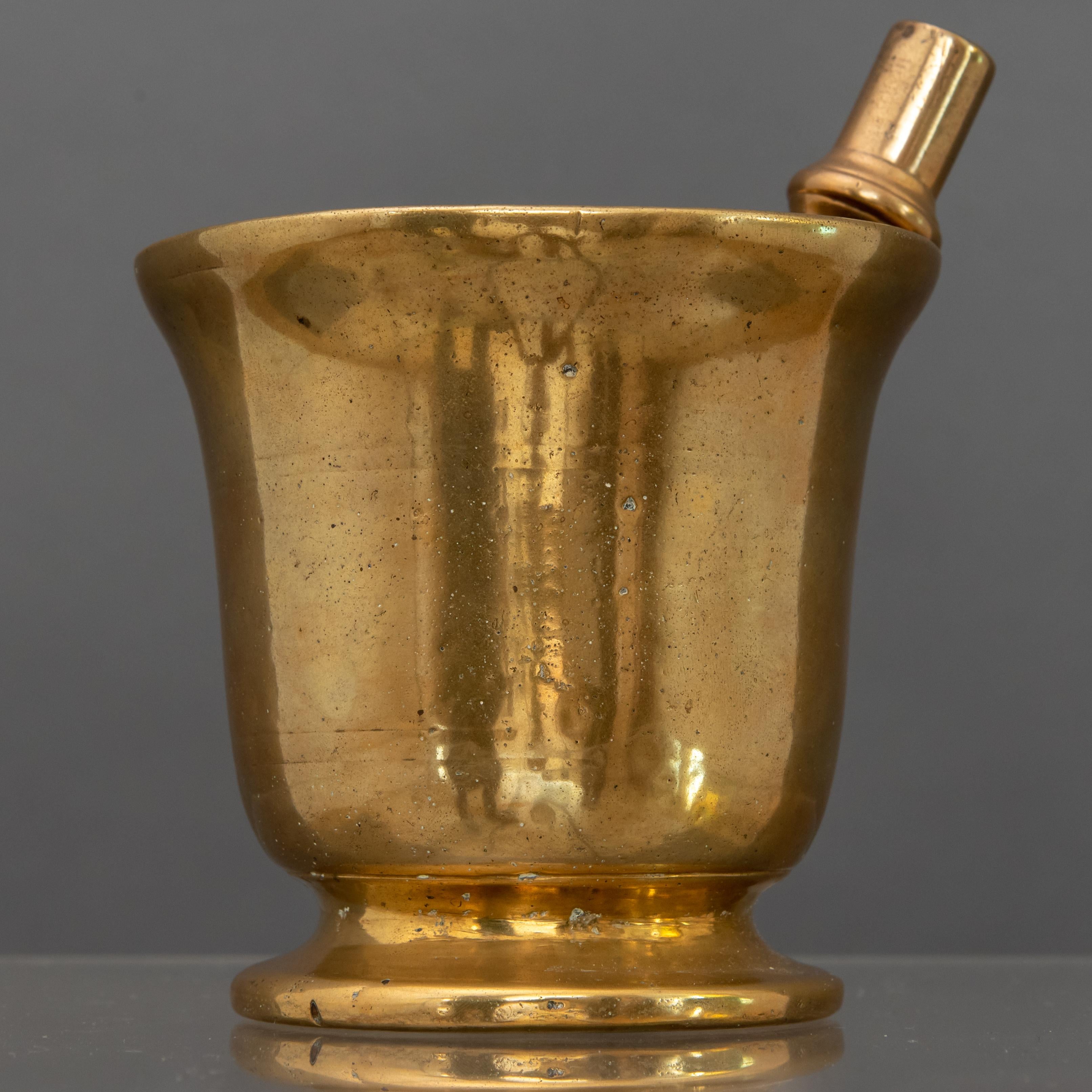 Gilded bronze mortar with a smooth cylindrical shape and wide mouth, complete with its original pestle.
Italy, 18th century

Every item of our Gallery, upon request, is accompanied by a certificate of authenticity issued by Sabrina Egidi official