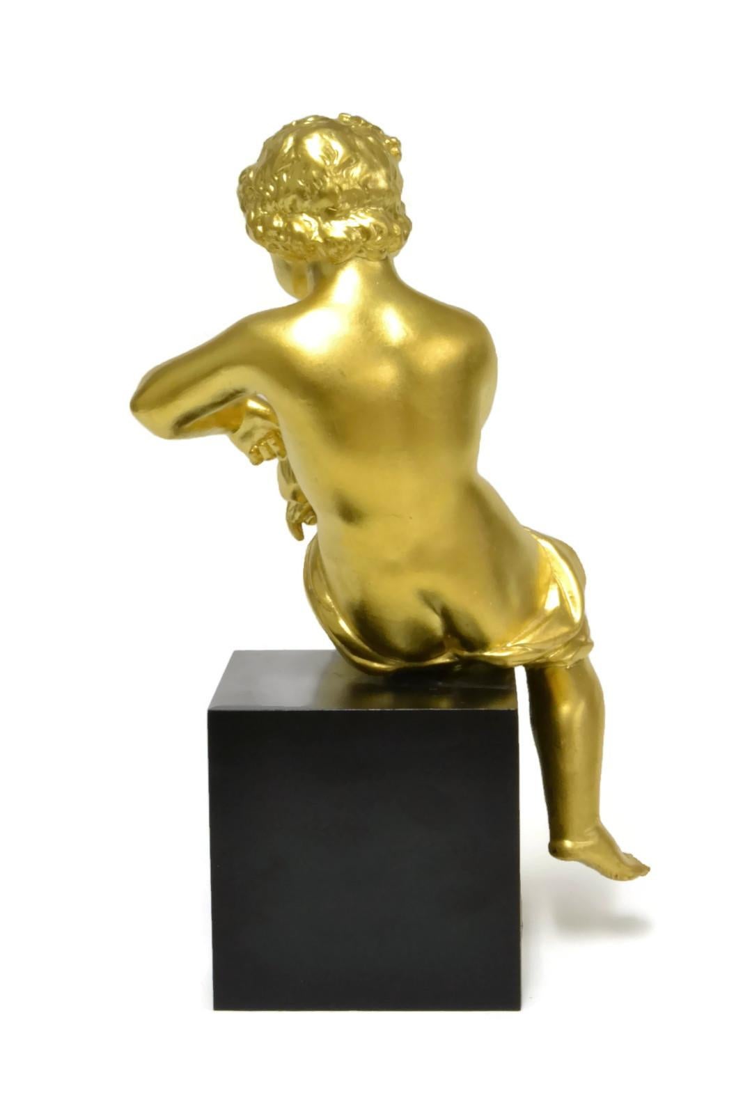 A 19th century bronze Putto 13 inches head to toe mounted on a (later) black metal base 4.5