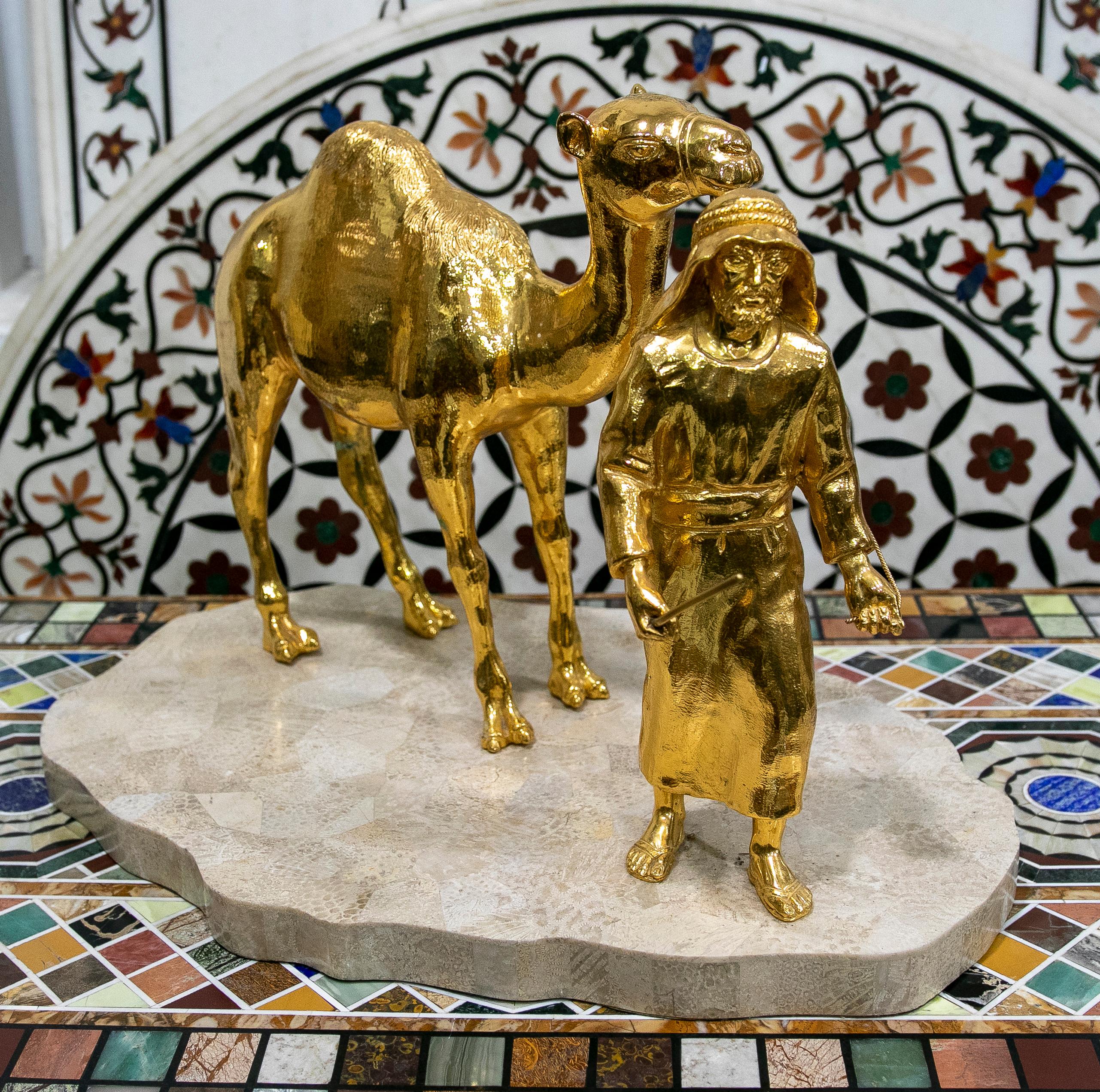 Gilded bronze sculpture with marble base of an arabic man with a horse.