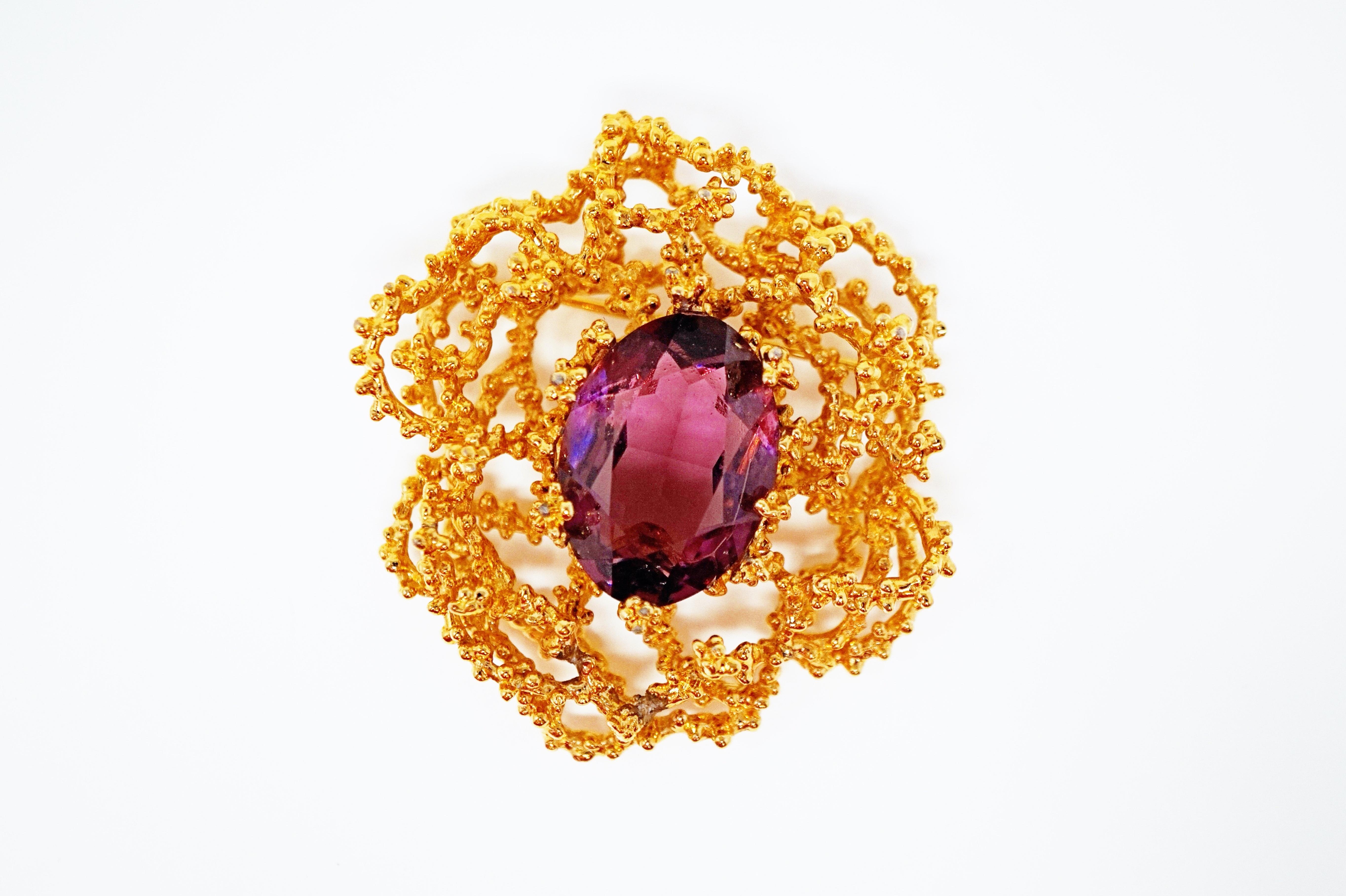 Exquisite gilt Brutalist-style abstract modern brooch with faceted Amethyst-colored crystal centerpiece by Panetta, circa 1960.  

Gold-plated metal combined with sparkling deep purple crystal create a bold look that is just as on trend today as it