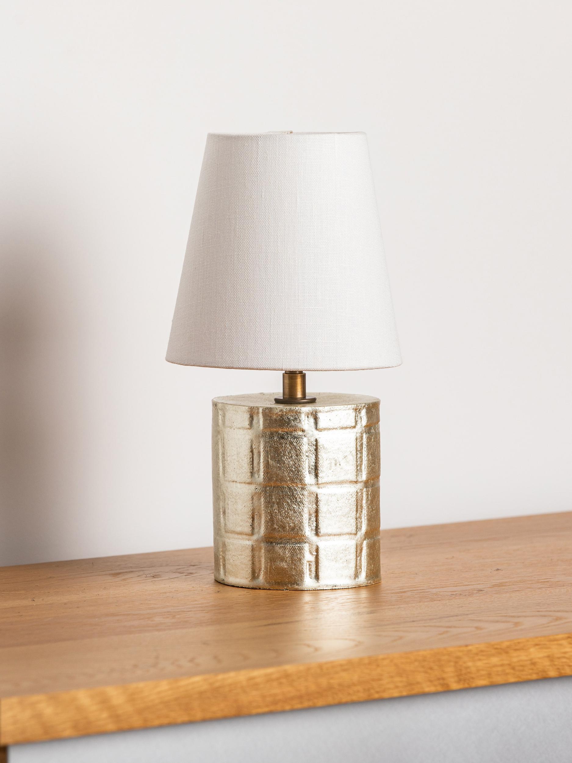 This limited edition Cornwall lamp is the product of our collaboration with artist and master-gilder Carol Leskanic. Once glazed, 12K-white-gold leaf is applied to the handcrafted stoneware using a traditional oil gilding method.

Finish

-
