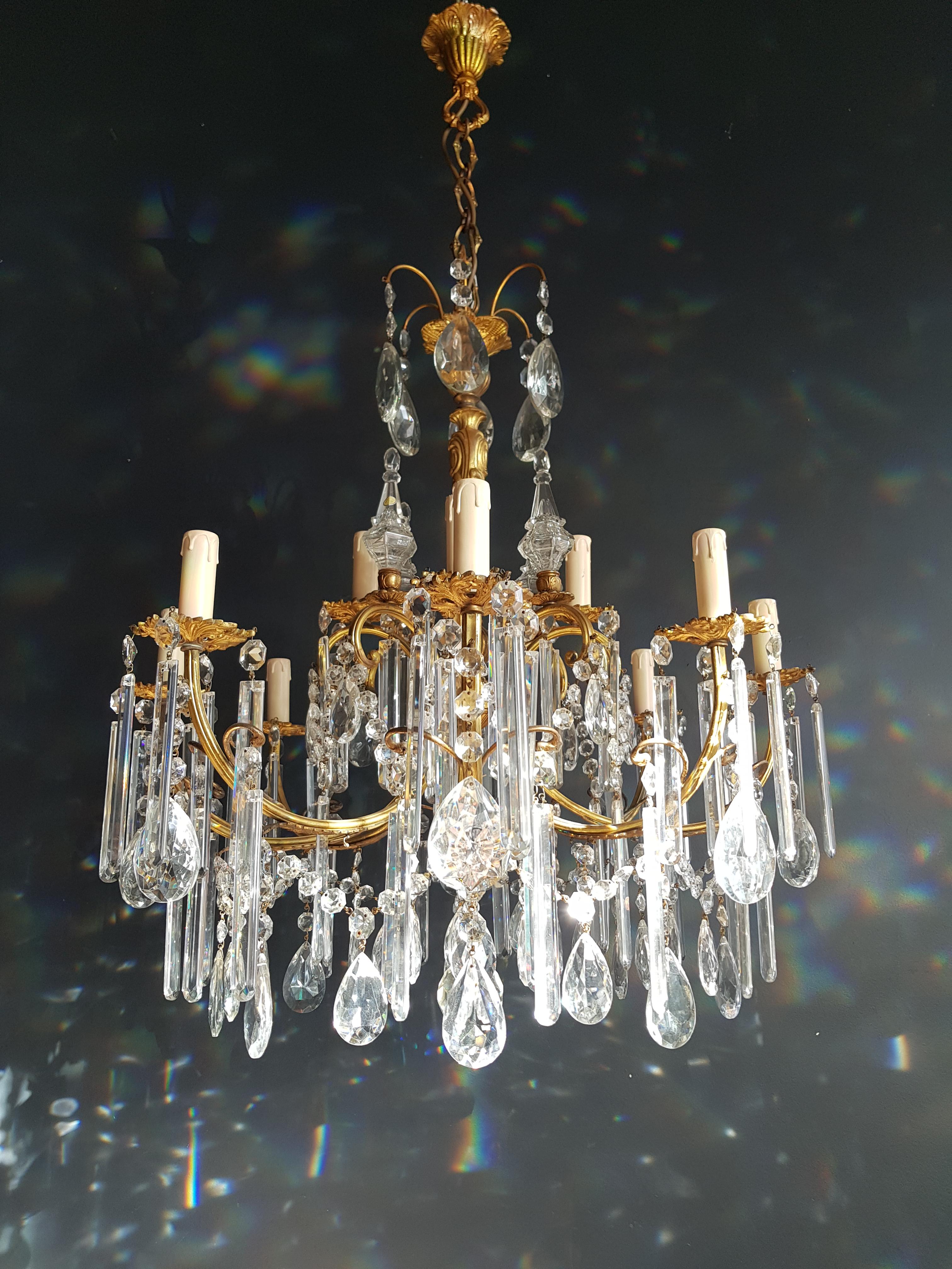 This beautiful twelve-light chandelier has a gilded brass frame. Cut crystal Bohemia tear drops hang over octagonal crystal chains. Long Bohemia crystal drops hang all-over the chandelier arms.

Measures: Total height 150 cm, height without chain