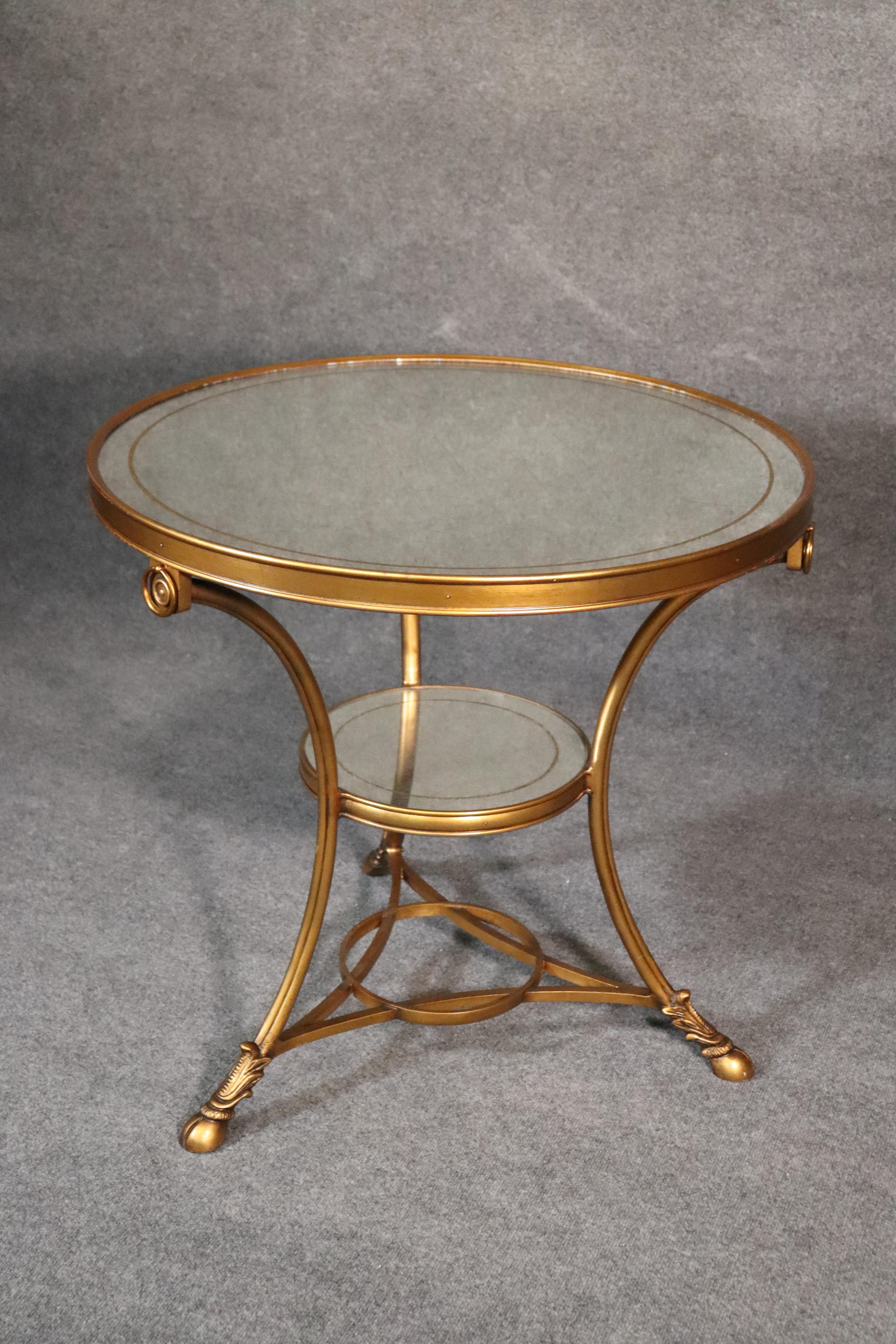 This is a fantastic gilded and silver leafed eglomise center table in the French Directoire style. The table has some minor signs of age that are mostly contained as small losses of gold surrounding the table top perimeter. The table has a gorgeous
