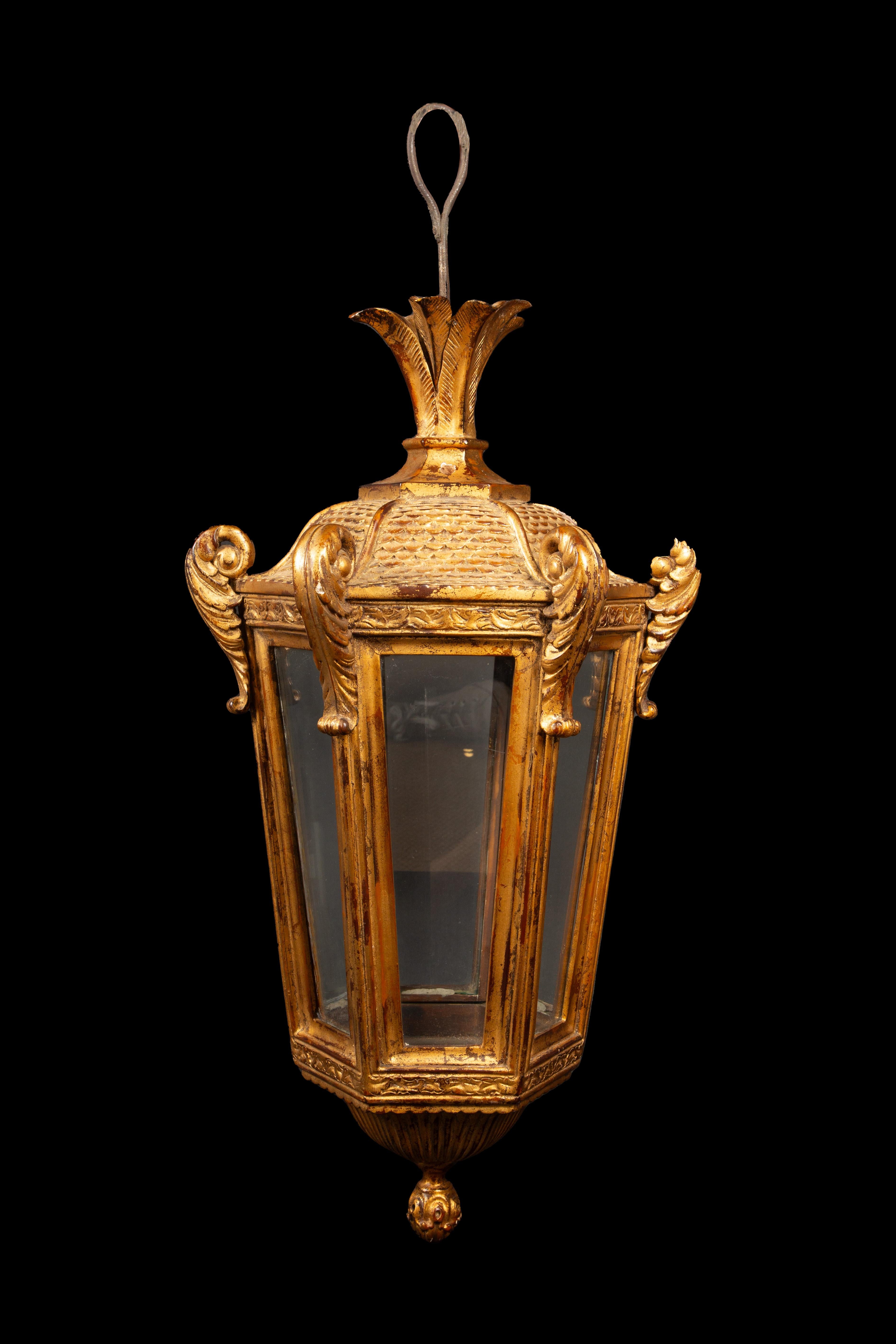 Exquisite 19th Century Carved and Gilt Wood Venetian Lantern. Crafted with meticulous artistry, this lantern's intricate carvings and lustrous gilt finish exude timeless elegance. Its glass doors offer a glimpse of the past, inviting you to
