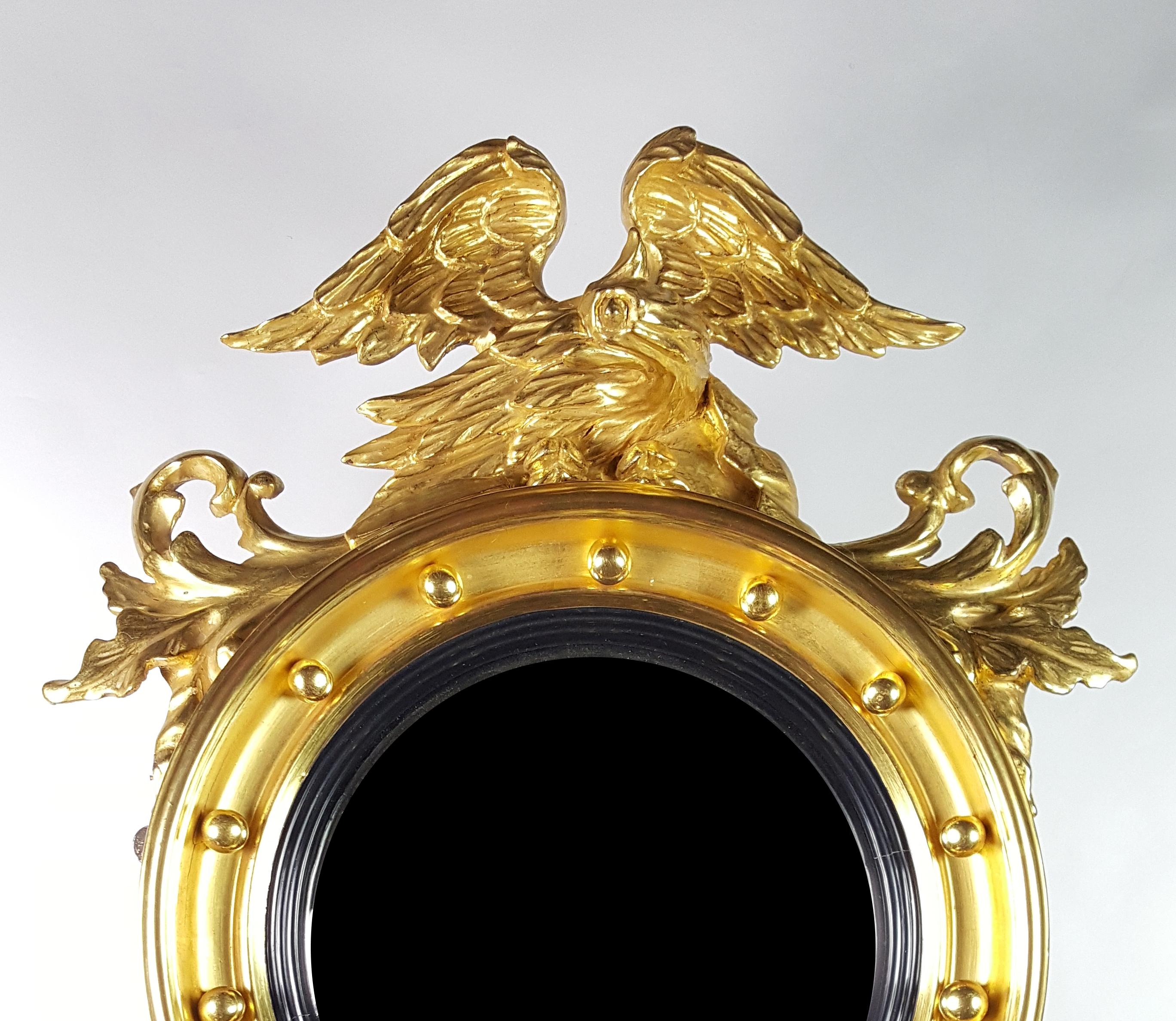 Gilded Federal American Eagle Convex Mirror, circa 1820
Gilded wood and gesso
Mirror diameter: 11 1/4 inches
Overall measurement: 29 1/2 x 21 1/2 inches (on the wall)

This console mirror It is constructed of wood and gesso and gilded. On top