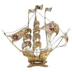 Gilded filigree caravel with enameled crosses on scalloped base