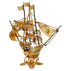 Gilded filigree caravel with enameled crosses on scalloped base