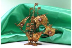 Gilded filigree caravel with Portuguese arms on scalloped base