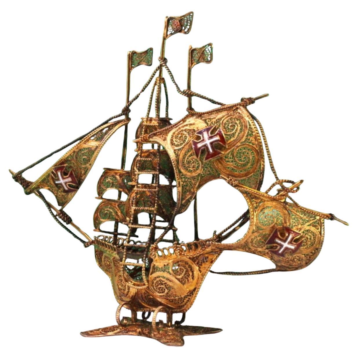 Gilded filigree caravel with Portuguese arms on scalloped base