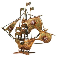 Gilded filigree caravel with Portuguese arms on scalloped base
