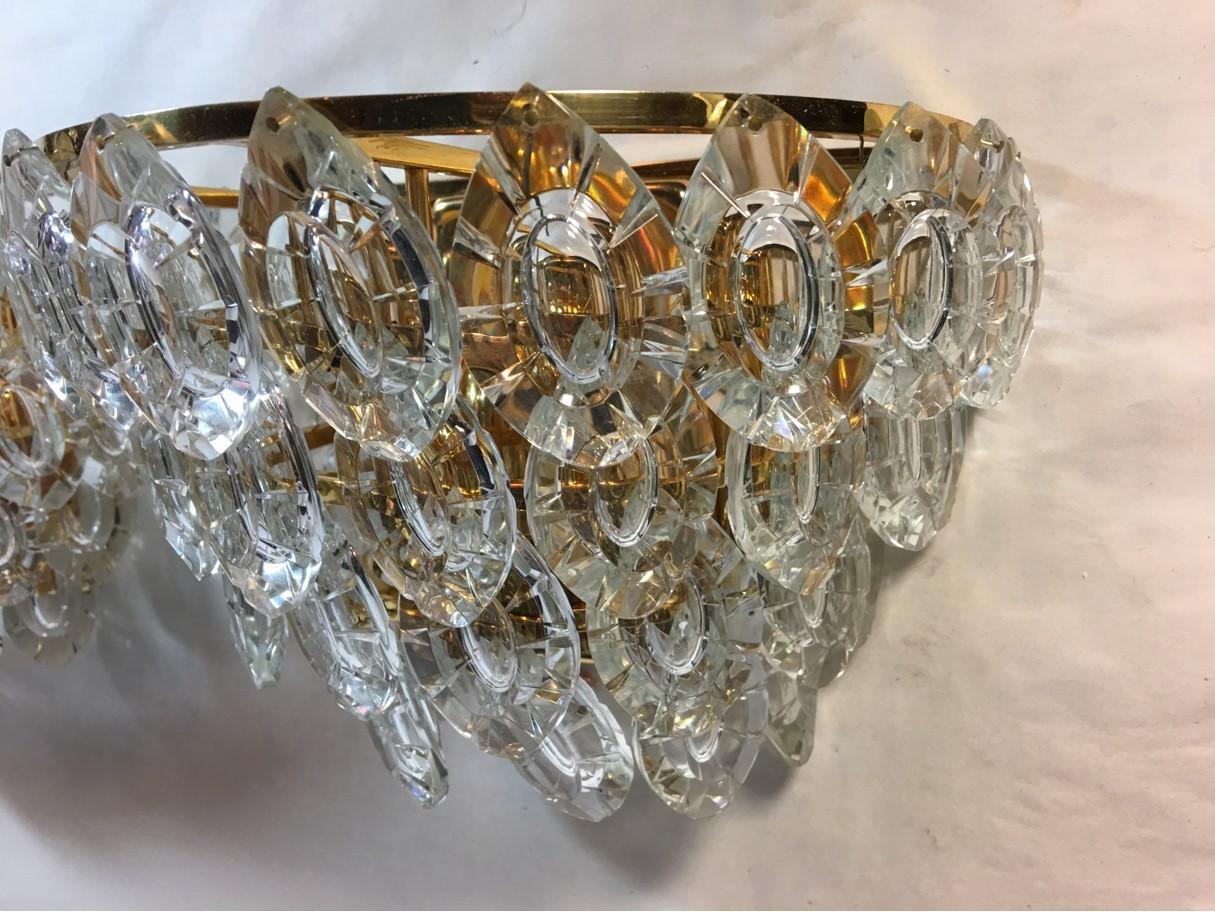 Lovely gilded four-tiered crystal sconces from 1970s, Austria. Dancing to Mozart under the lovely lights of this Austrian set of four-tiered crystal sconces will transfer you into another time. Each fixture requires three European E14 candelabra