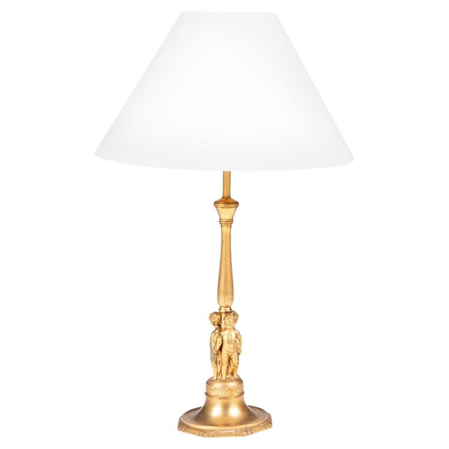 Gilded French table lamp with putti.