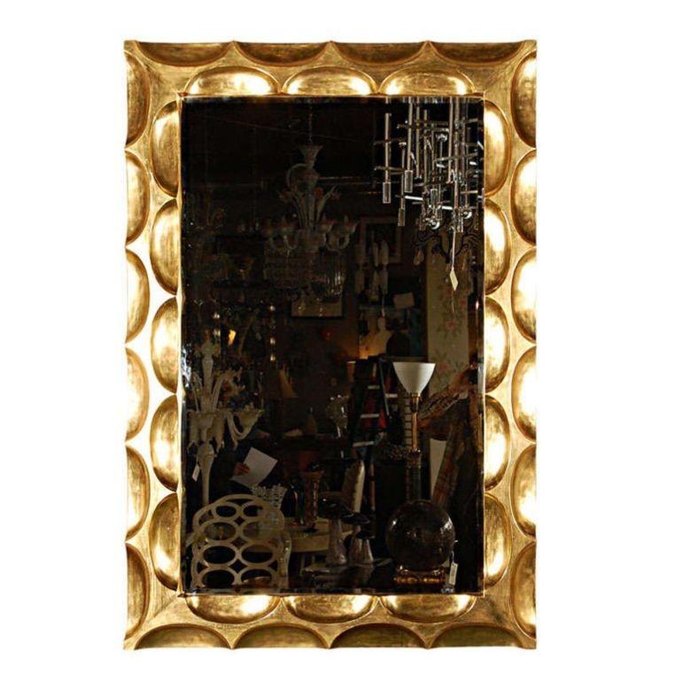 A vintage gilded hand-carved 'honeycomb' mirror by Bryan Cox. It is gilded in real 22-karat gold and has a beautiful deep relief carved design all around the piece. Mirror is beveled.
Dimensions:
58