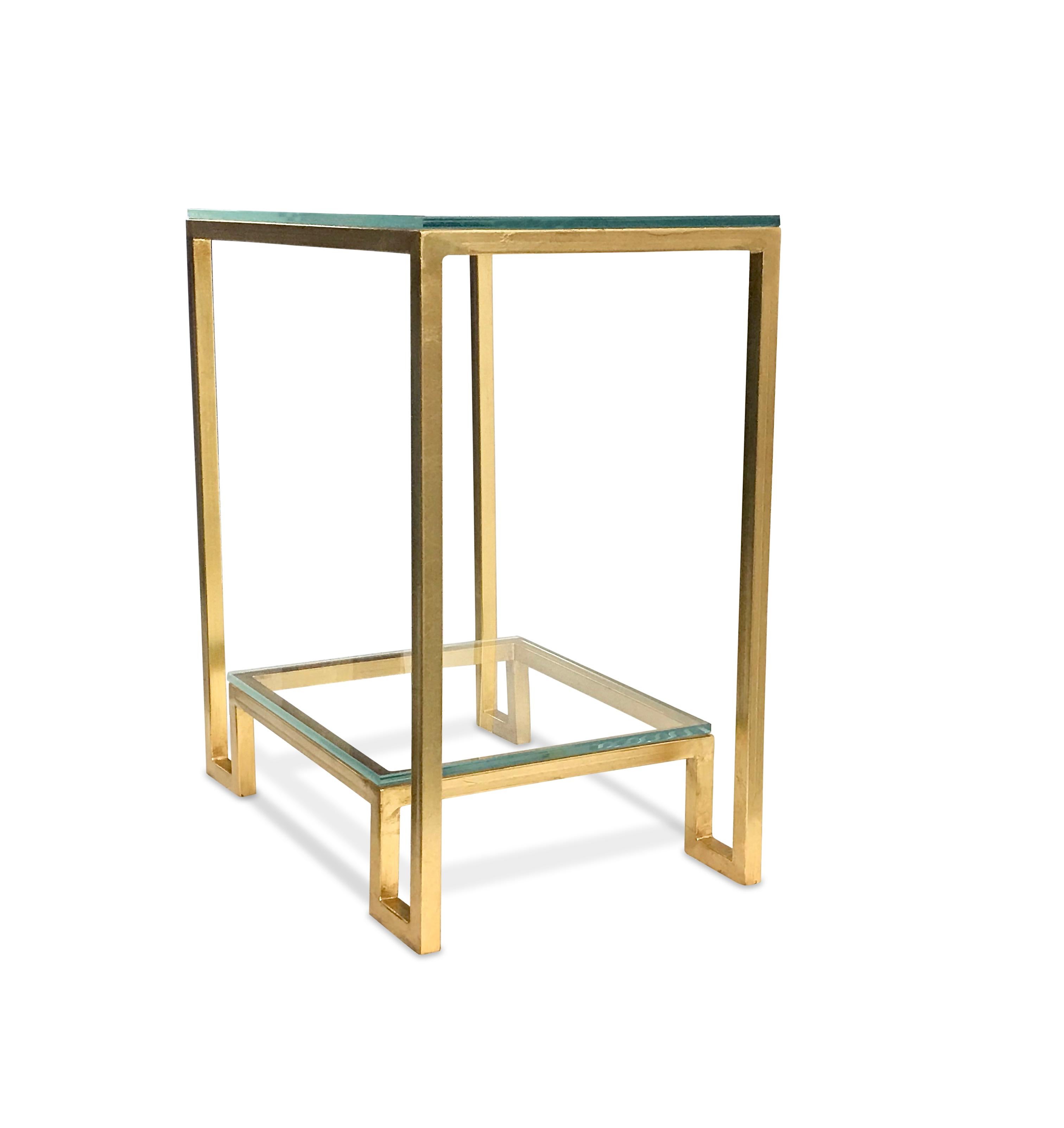 Contemporary iron based side table, gilded with gold leaves with two shelves each topped with a brand new thick glass. The glass edges are polished.

 
