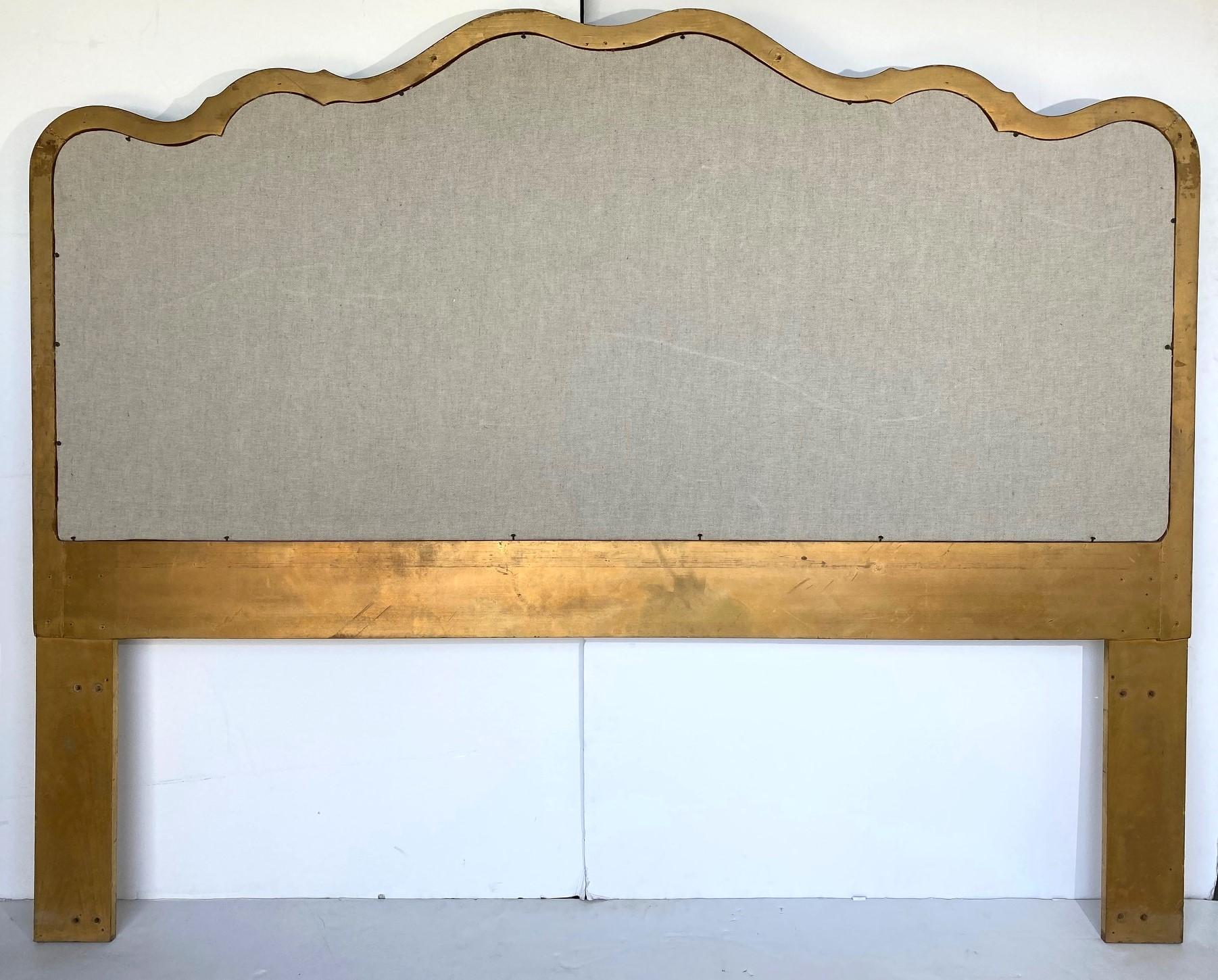 A king-size wood frame headboard gilded and upholstered in linen.
 