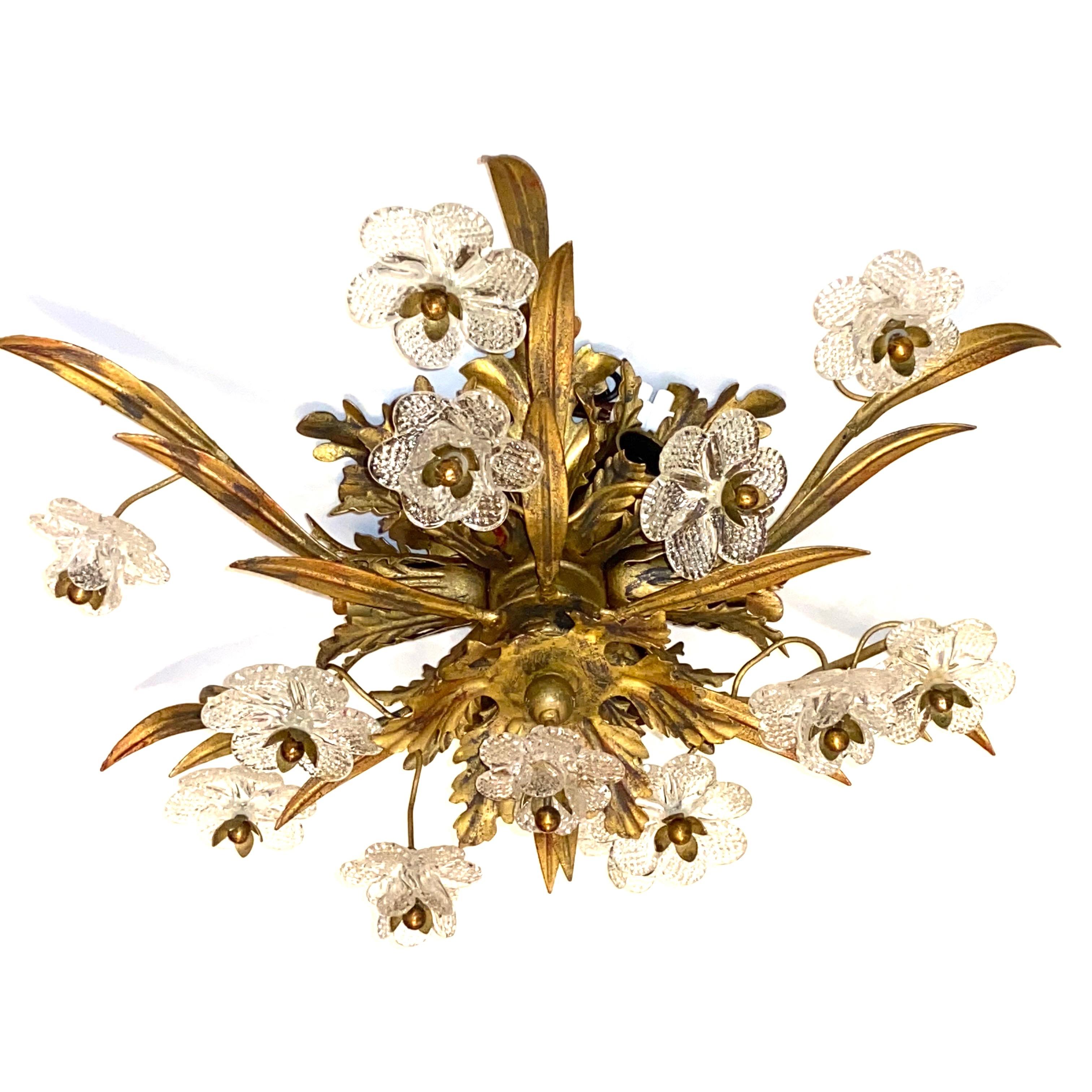 Add a touch of opulence to your home with this charming flushmount. Perfect gilt metal leafs with handmade Murano glass flowers to enhance any chic or eclectic home. We'd love to see it hanging in an entryway as a charming welcome home. Built in the