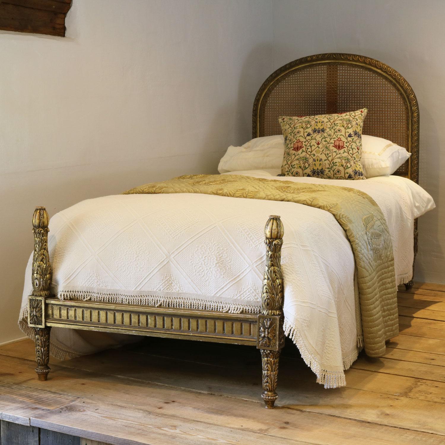 This stunning pair of matching single beds are in the Louis XVI style, and have caned rattan head boards and gilded frame. 

The price is for the beds and two standard firm bed bases. The mattresses and bedding are extra and can be
