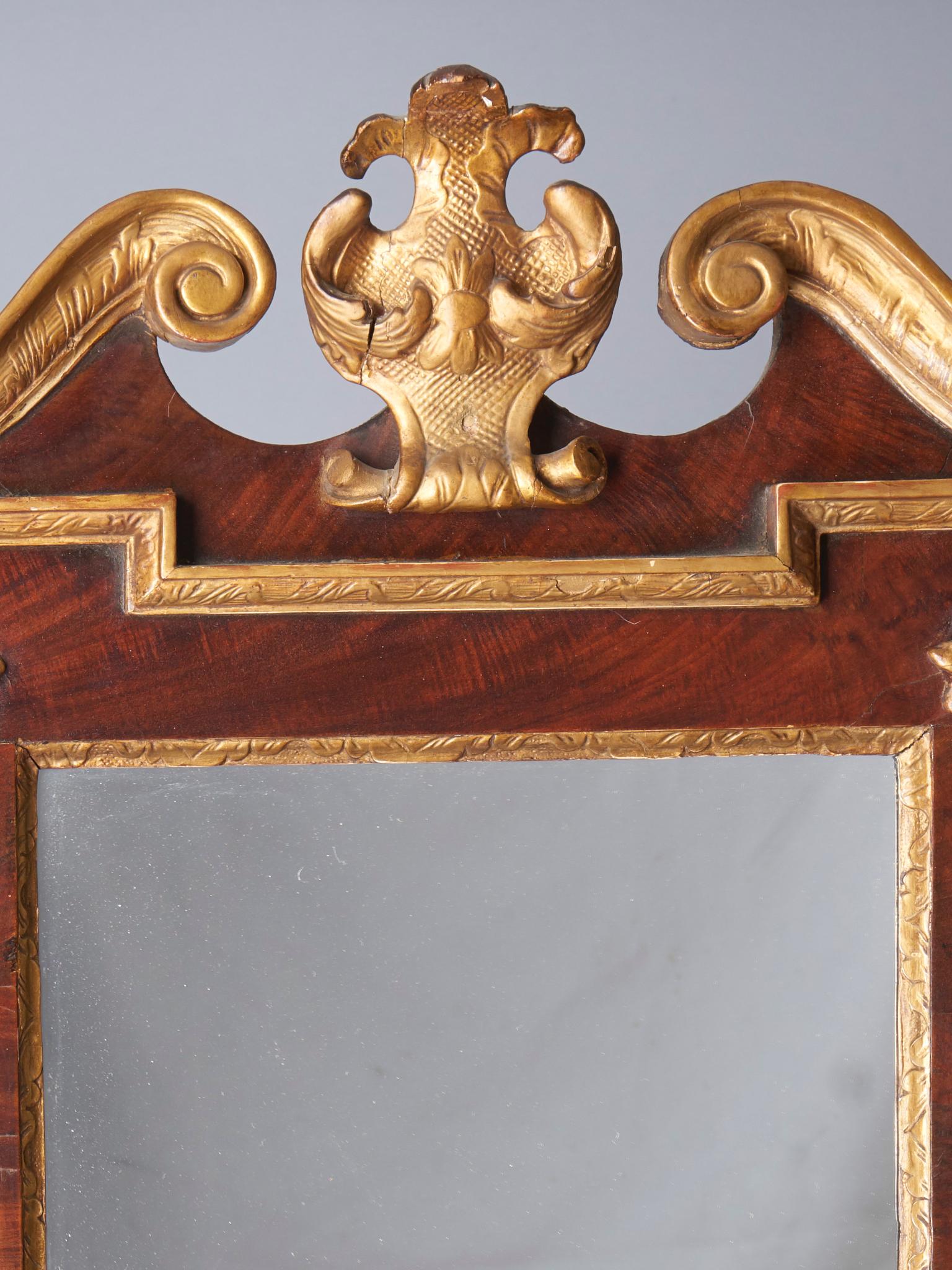 Gilded swags, scrolls and cartouche on mahogany. English, circa 1760.