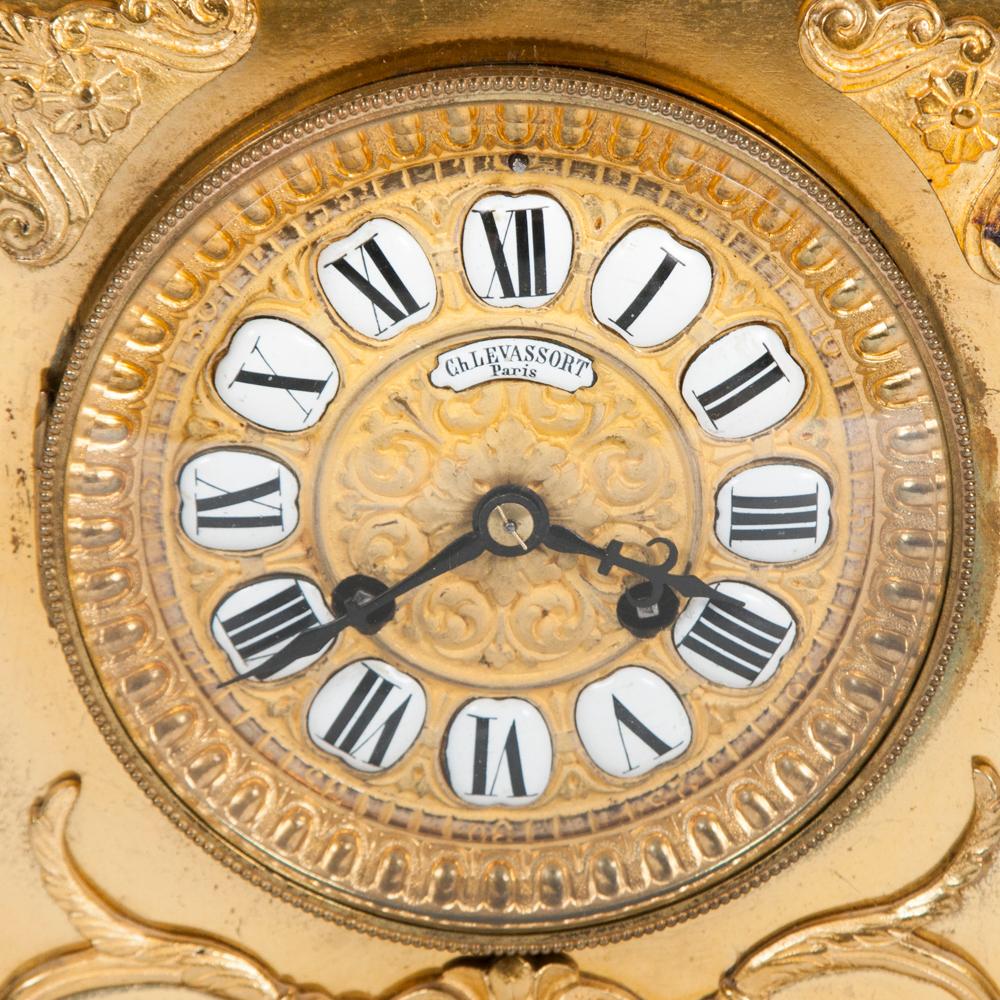 A late 19th century gilt mantle clock by Ch Levassort of Paris. Circa 1880.

The dial marked in Roman numerals, with each hour in an enamel cartouche.

The twin train movement strikes the hour and half hours on a bell, the backplate is marked 