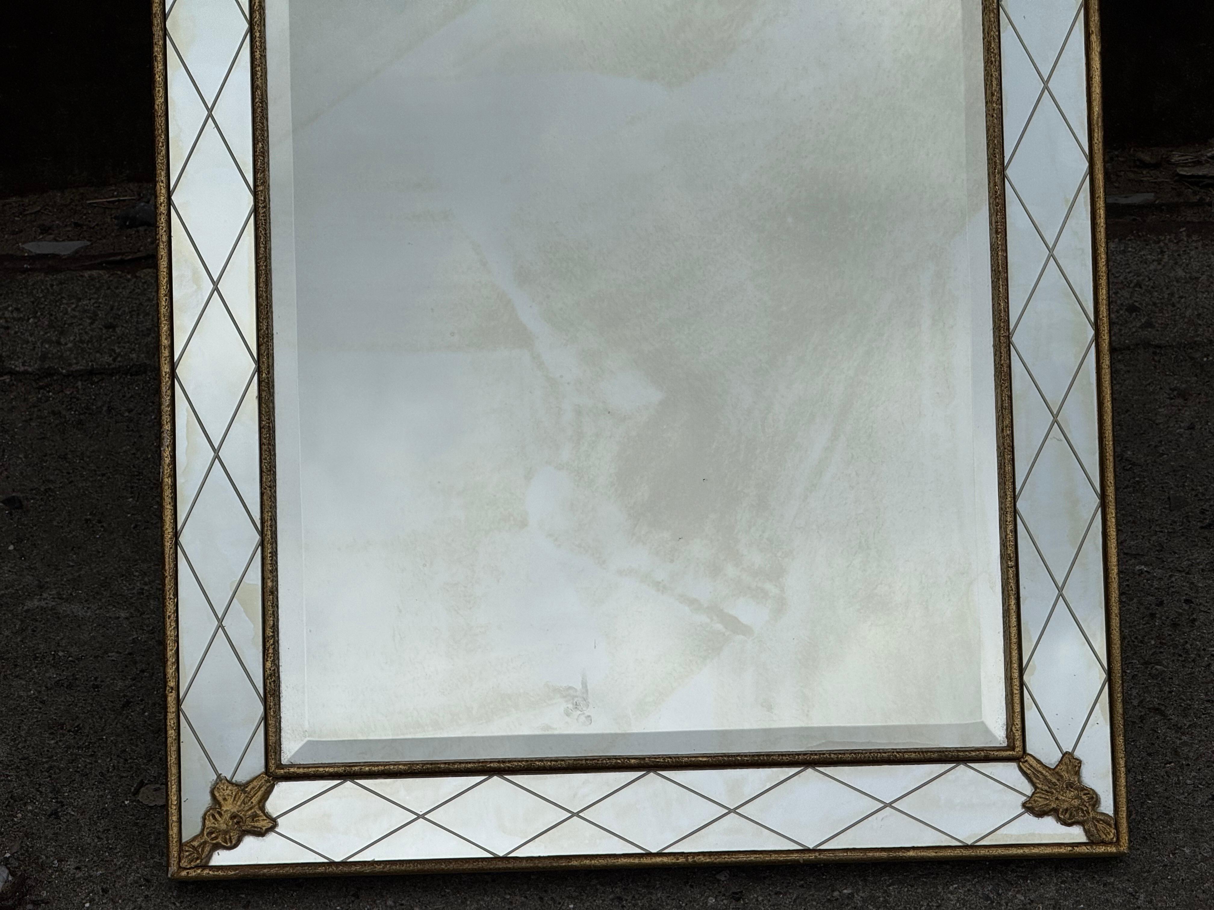 Elegant and rare Mid-Century Modern Scandinavian harlequin mirror from the 1950s. Measuring 116 cm in height and 54 cm in width, this piece features a refined gilted frame with a hand-painted diamond motif and corner rosettes. The mirror’s classical