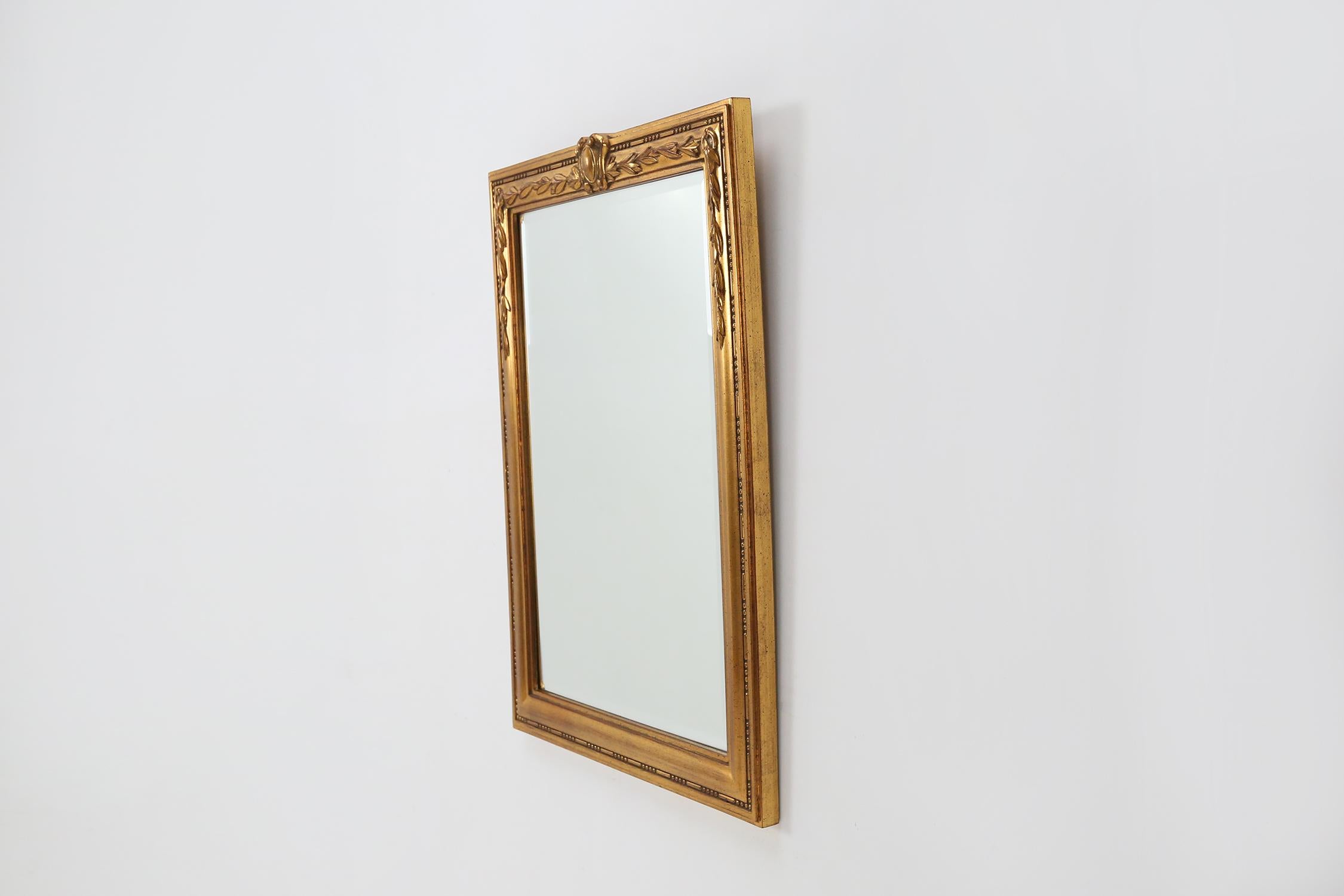 Miroir doré fabriqué en Belgique vers 1970.
Whit a de beaux détails sculpturaux.