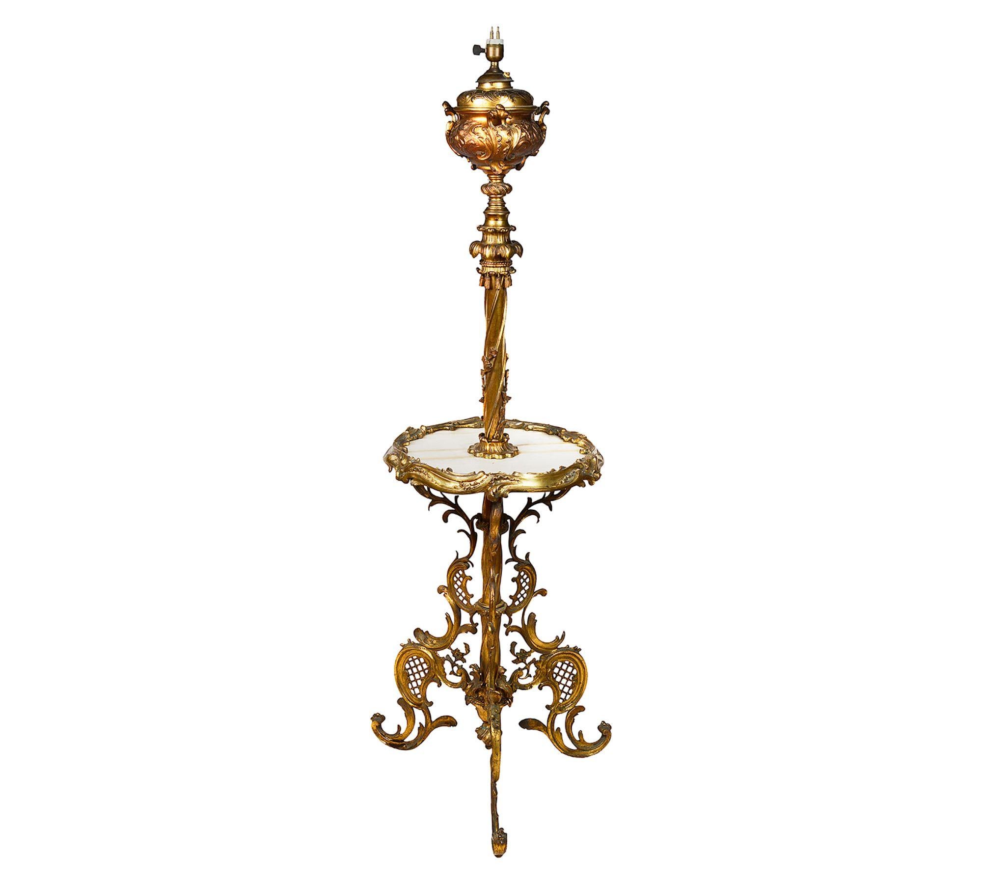 A good quality late 19th Century French gilded ormolu standard oil lamp. Having scrolling foliate decoration, an inset marble top supported by a rococo influenced ormolu tripod base.
 
 
Batch 74 G9947/23. SNYZ