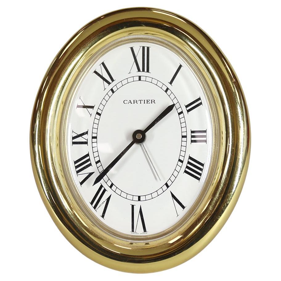 Horloge d'alarme Cartier ovale dorée