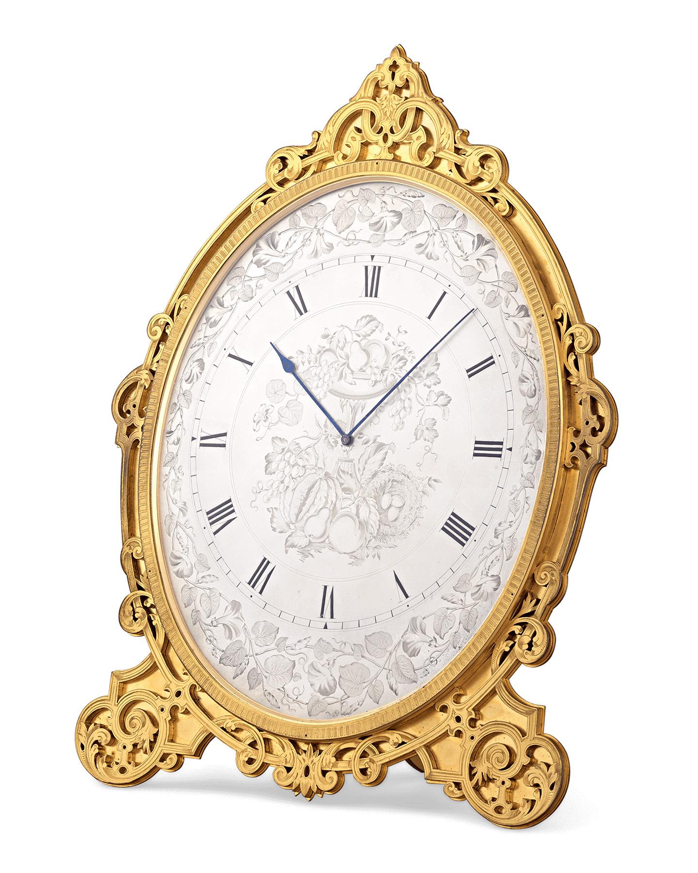 Crafted by the great Victorian clockmaker Thomas Cole, this elegantly gilded 30-hour timepiece is a pristine example of the portable “strut clocks” which skyrocketed the English horologist’s fame. The oval dial features a silvered engraving of a