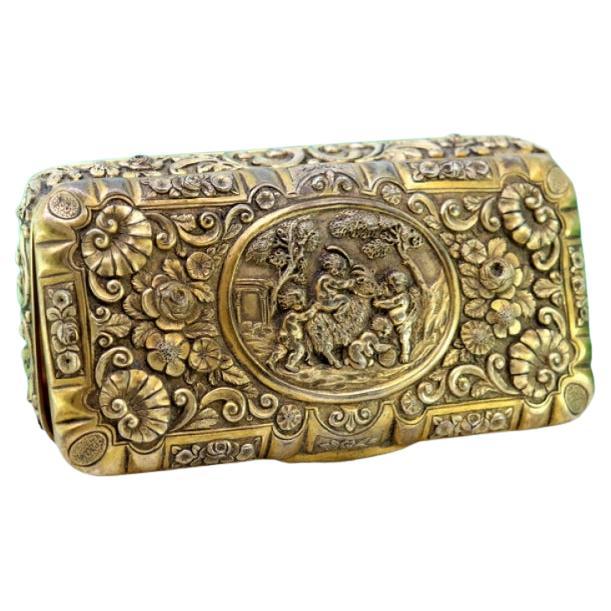 Gilded silver box with floral motifs, children scene and gold interior