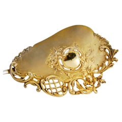 Gilded silver cake paddle with cutout shells, flowers, and grape handle