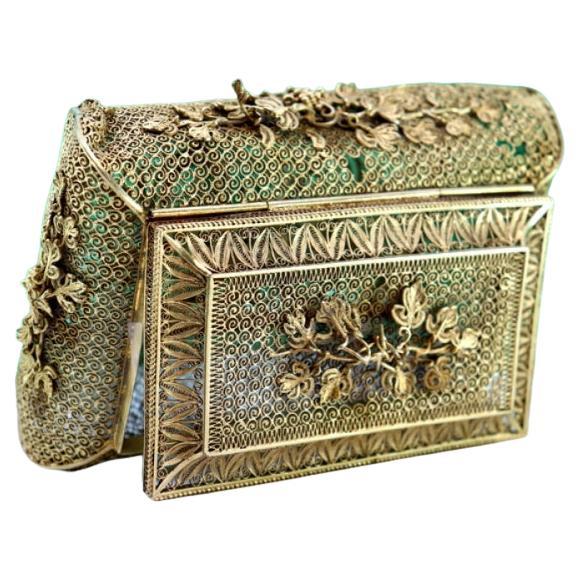 Gilded silver filigree box with floral applications and hinged lid