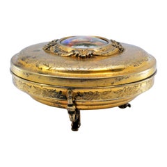 Gilded silver jewelry box with reliefs and enamel gallant-scene lid
