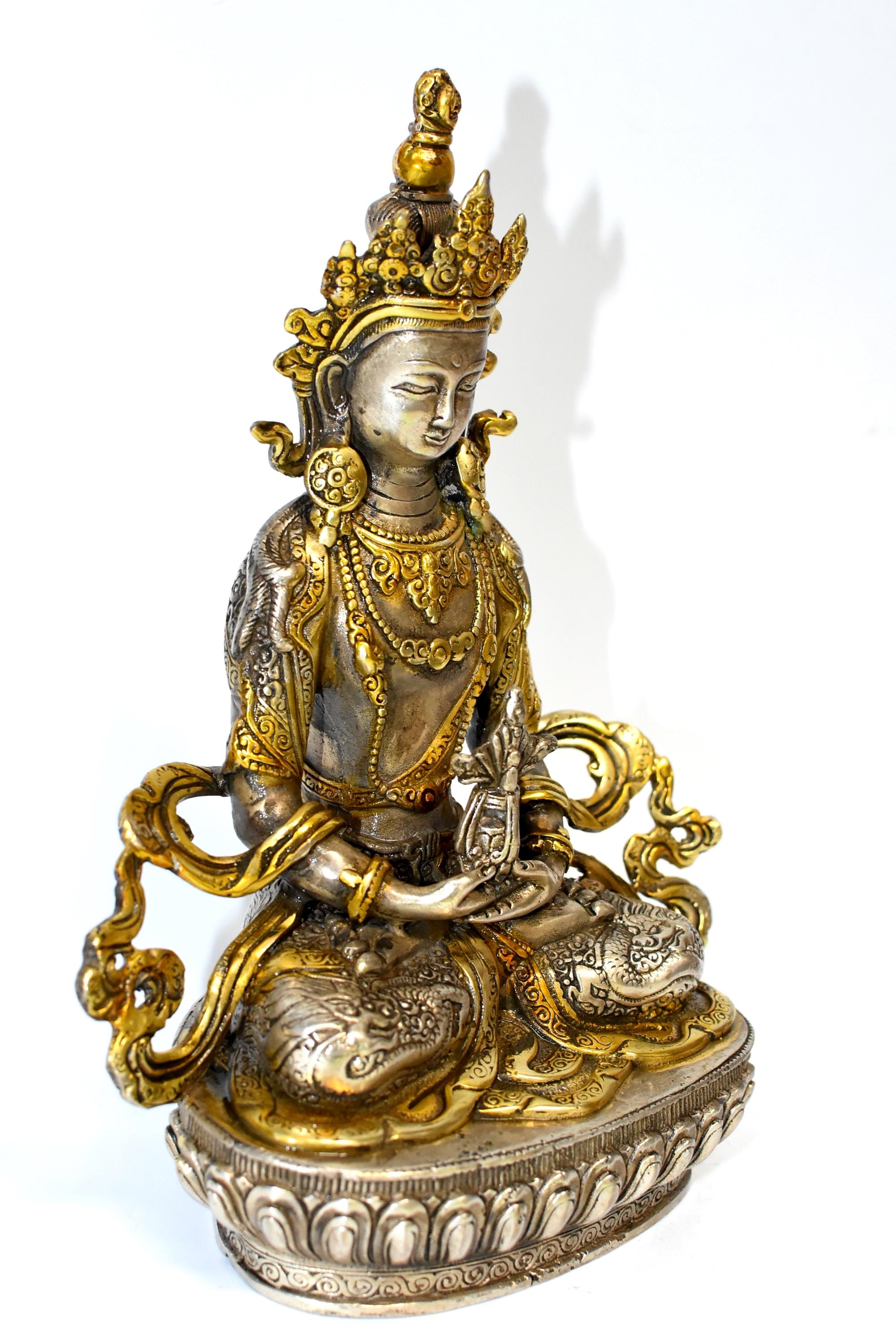 A beautiful statue of Tibetan Bodhisattva Amitayus. The god of longevity, he brings blessings of long life. In this statue he wears a high crown and an embossed skirt demonstrating lions and dragons. He holds the ambrosia vase which holds blessing