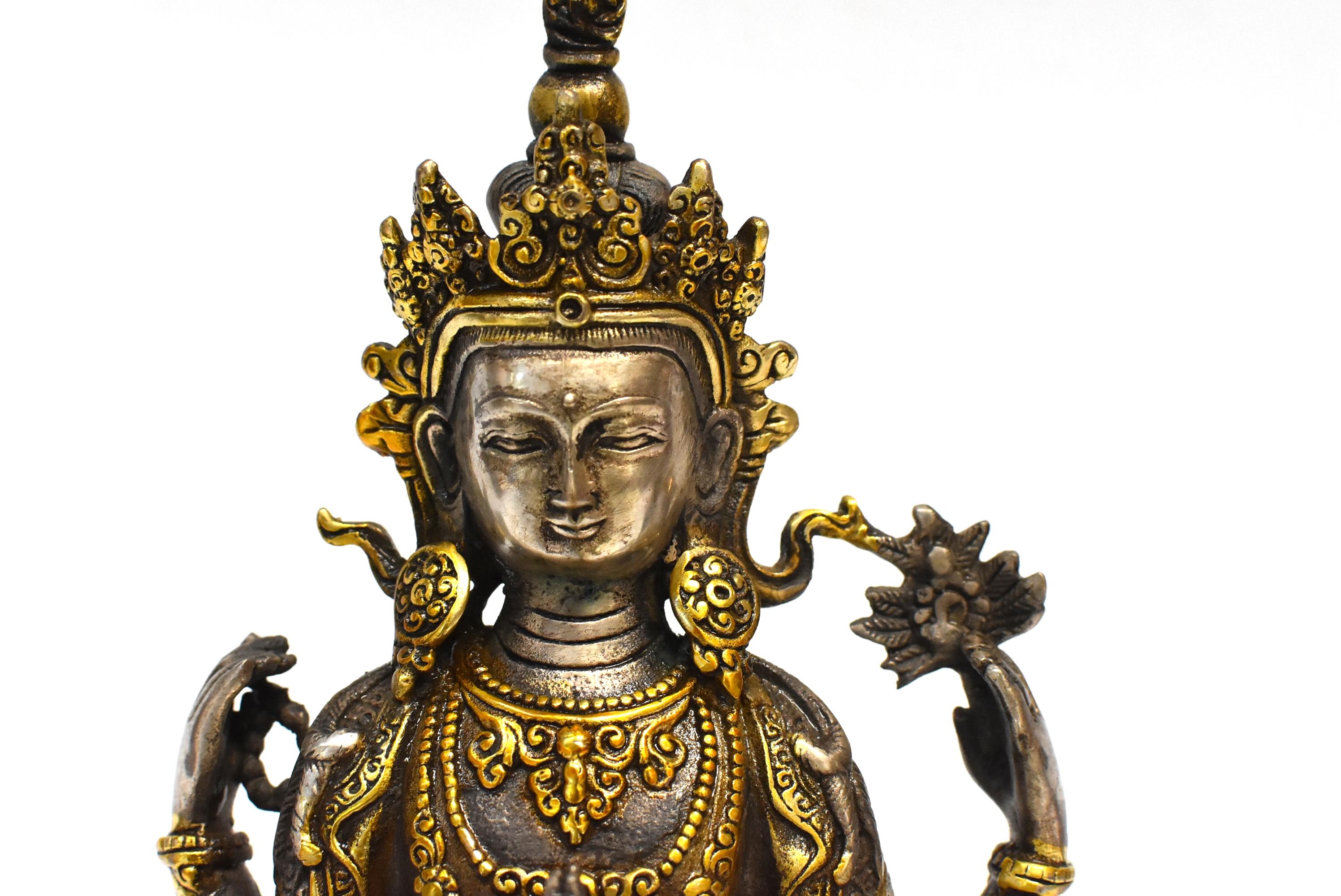 A beautiful statue of Tibetan Bodhisattva The White Tara. She is the Goddess of Great Compassion who is known to answer prayers quickly and bring blessings to people when they need them the most. In this statue she wears a high crown and an embossed