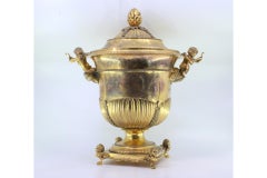 Gilded silver urn with fluting, vetelatistic motifs & winged-feet base