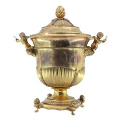Gilded silver urn with fluting, vetelatistic motifs & winged-feet base