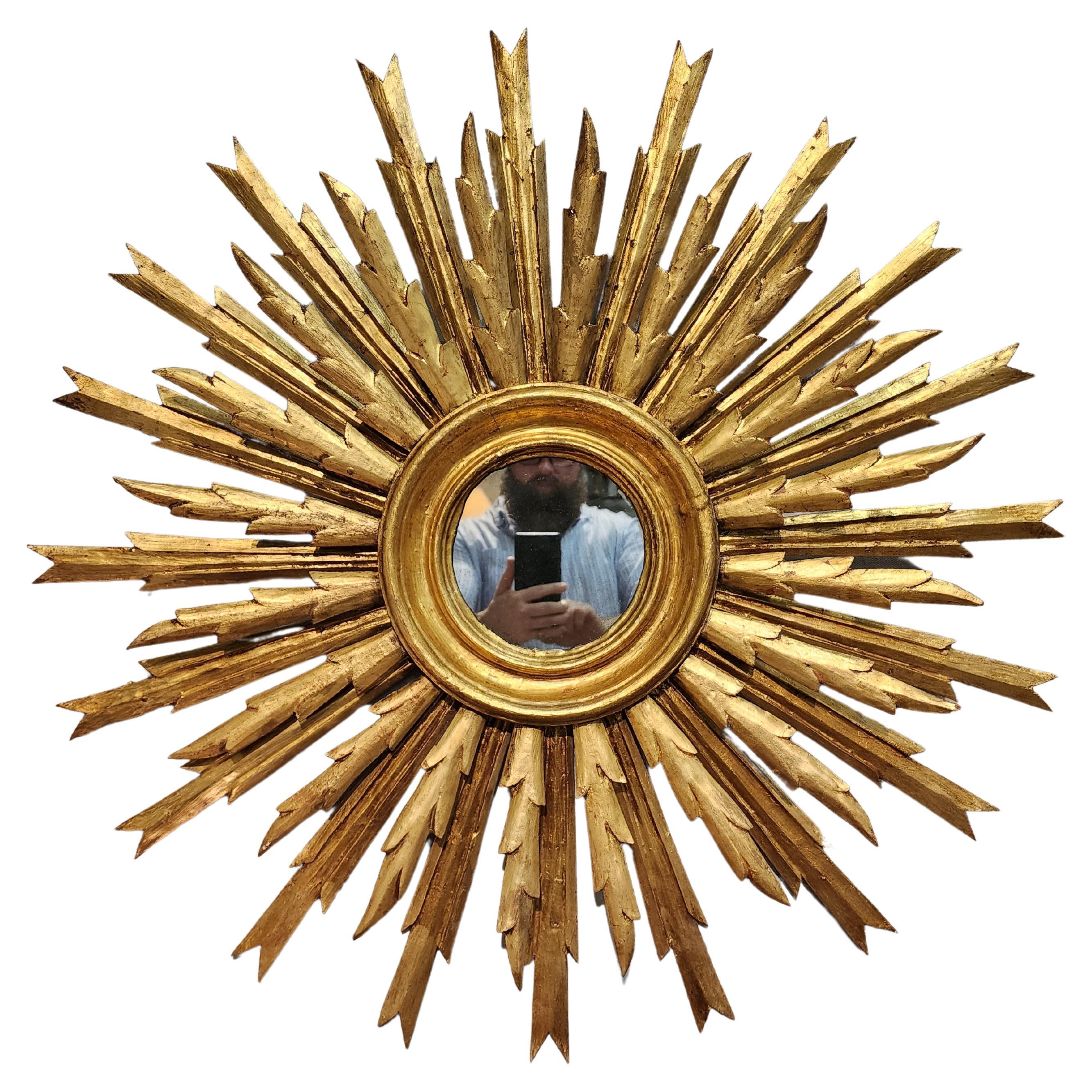 This is a beautiful and very well proportioned sunburst mirror. Made in Spain in the 1930s. This beauty retains the original gold gilded surface and mirror glass. It adds a bit of light and sunshine to any room.
Please be sure to contact me with