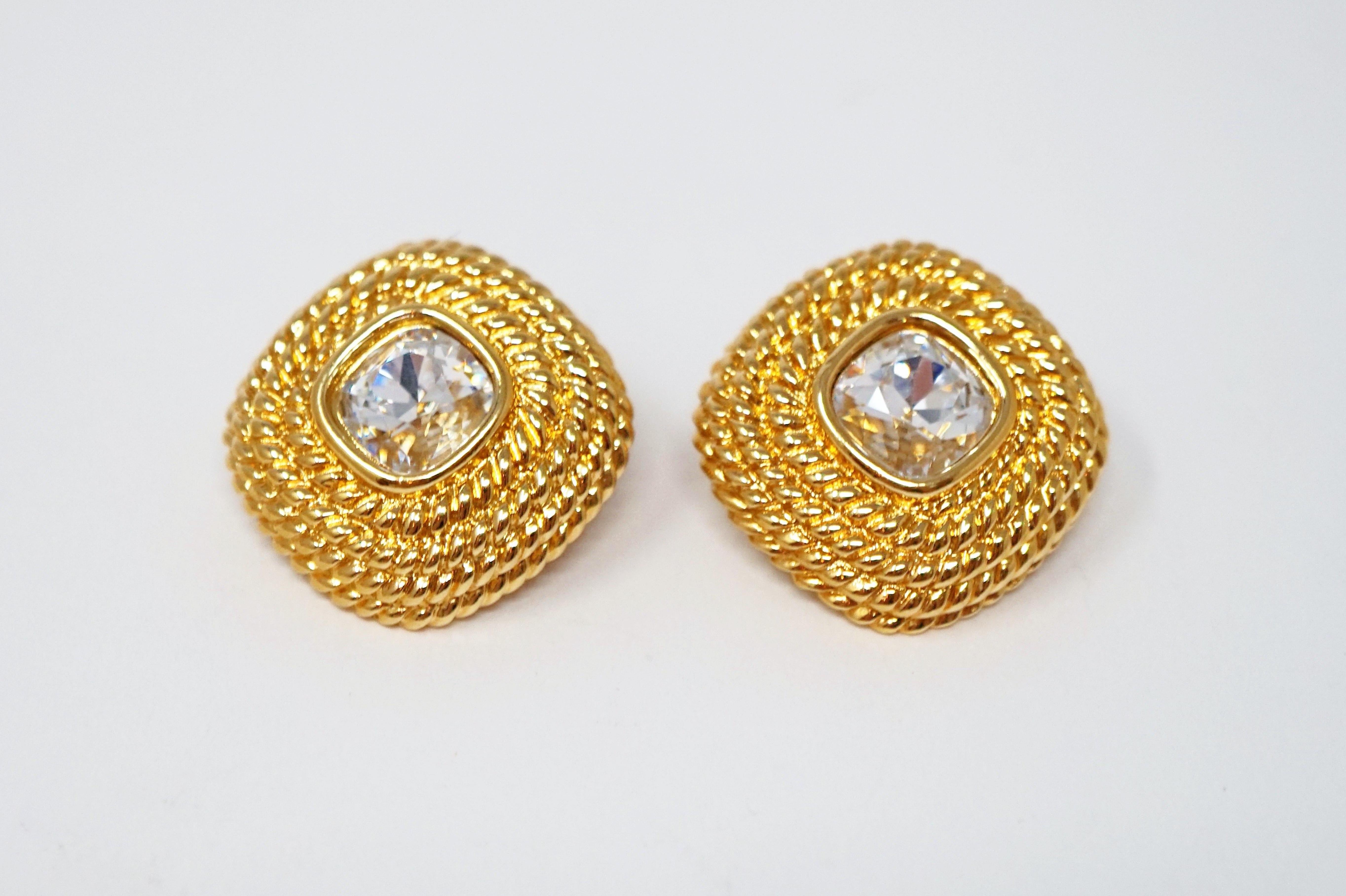 These gorgeous gold-plated statement earrings with faceted Swarovski crystal by Swarovski are perfect for adding a touch of sparkle to your look!  Classic braided texture frames a focal Swarovski crystal that catches the light beautifully.