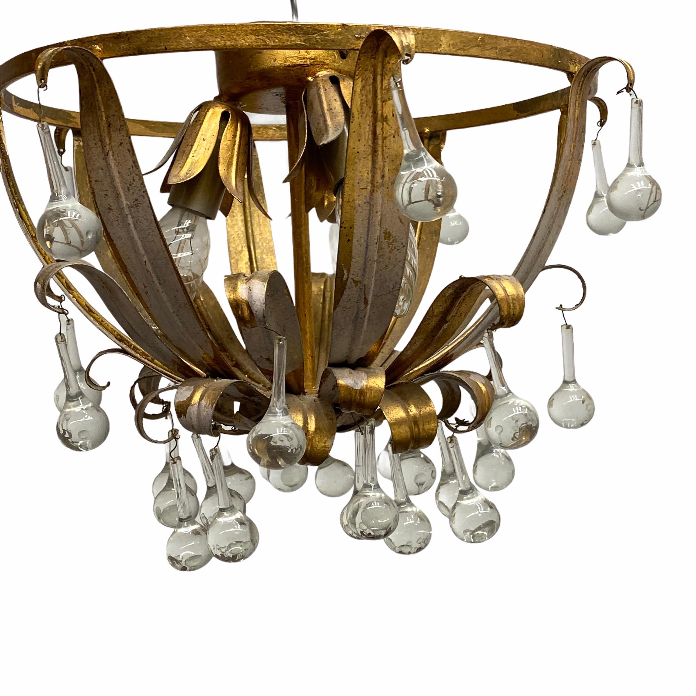 Add a touch of opulence to your home with this charming flush mount light. Perfect gilt metal leafs to enhance any chic or eclectic home. We'd love to see it hanging in an entryway as a charming welcome home. Built in the 1960s, made by Koegl