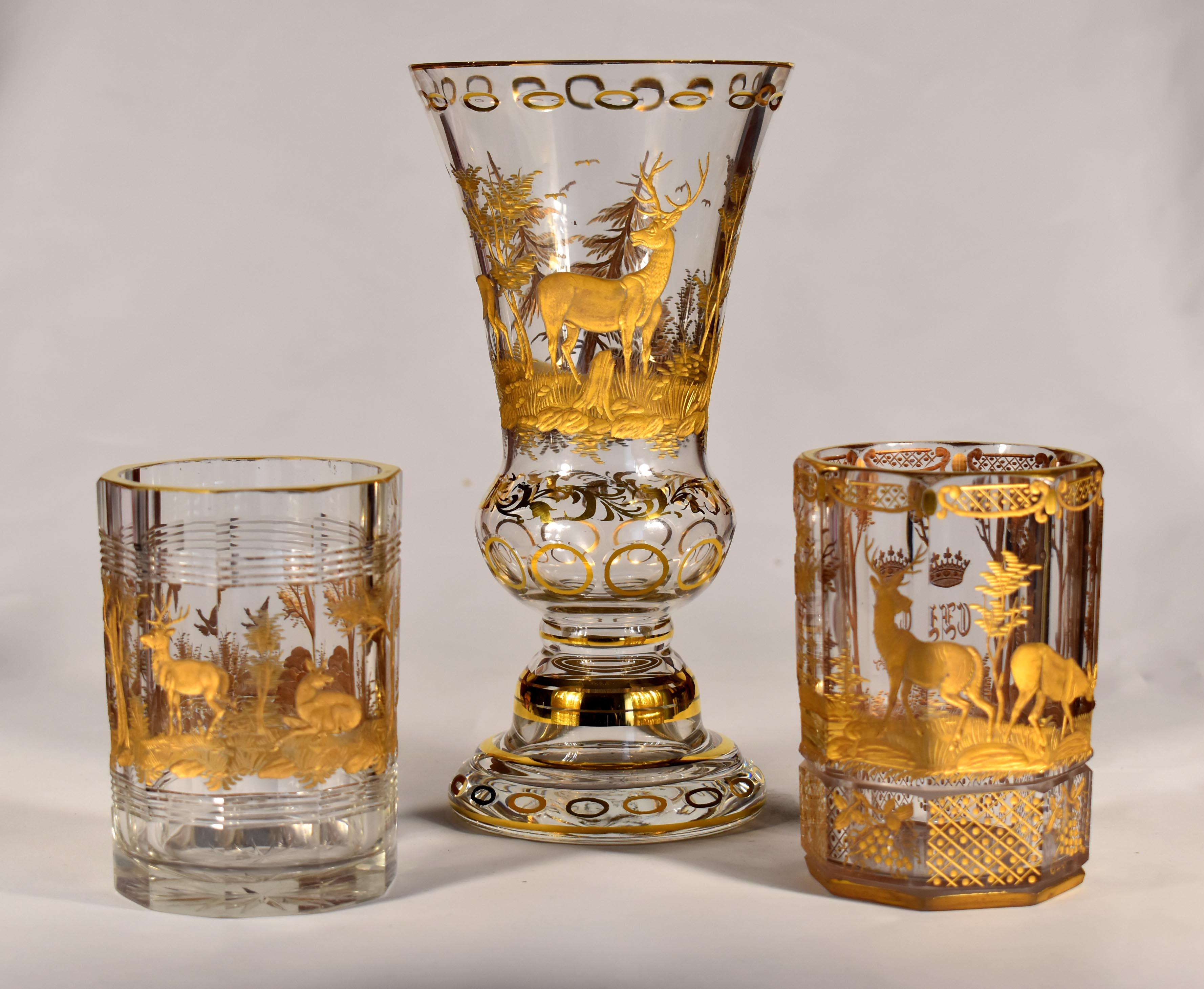 Convolute of three pieces of glass, This is a clear glass vase, Engraved hunting motif, The engraving is gilded. then two cut glasses also with an engraved hunting motif and then gilded, One of the glasses has an engraved and gilded noble crown with