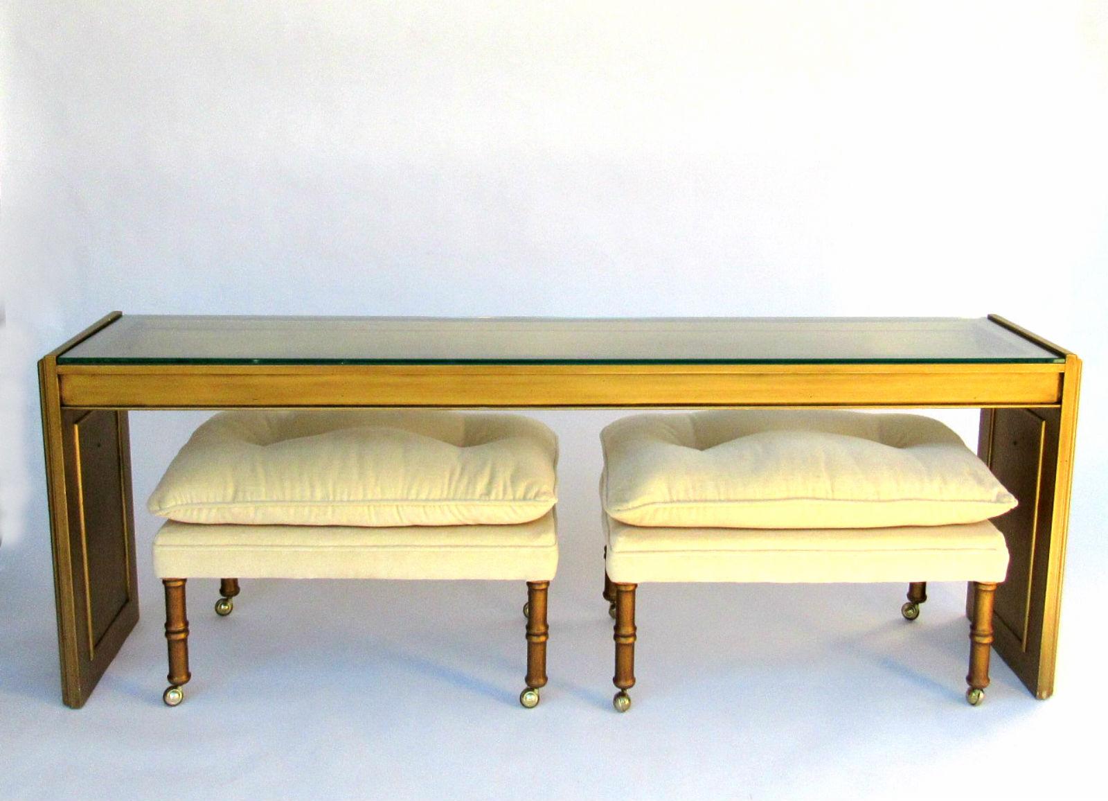 Gold Gilt painted wood and glass console from the 1970s. Stylish long console with glass insert top. Brass hardware on sides. Pair of faux bamboo stools shown in pictures available and listed separately for sale.