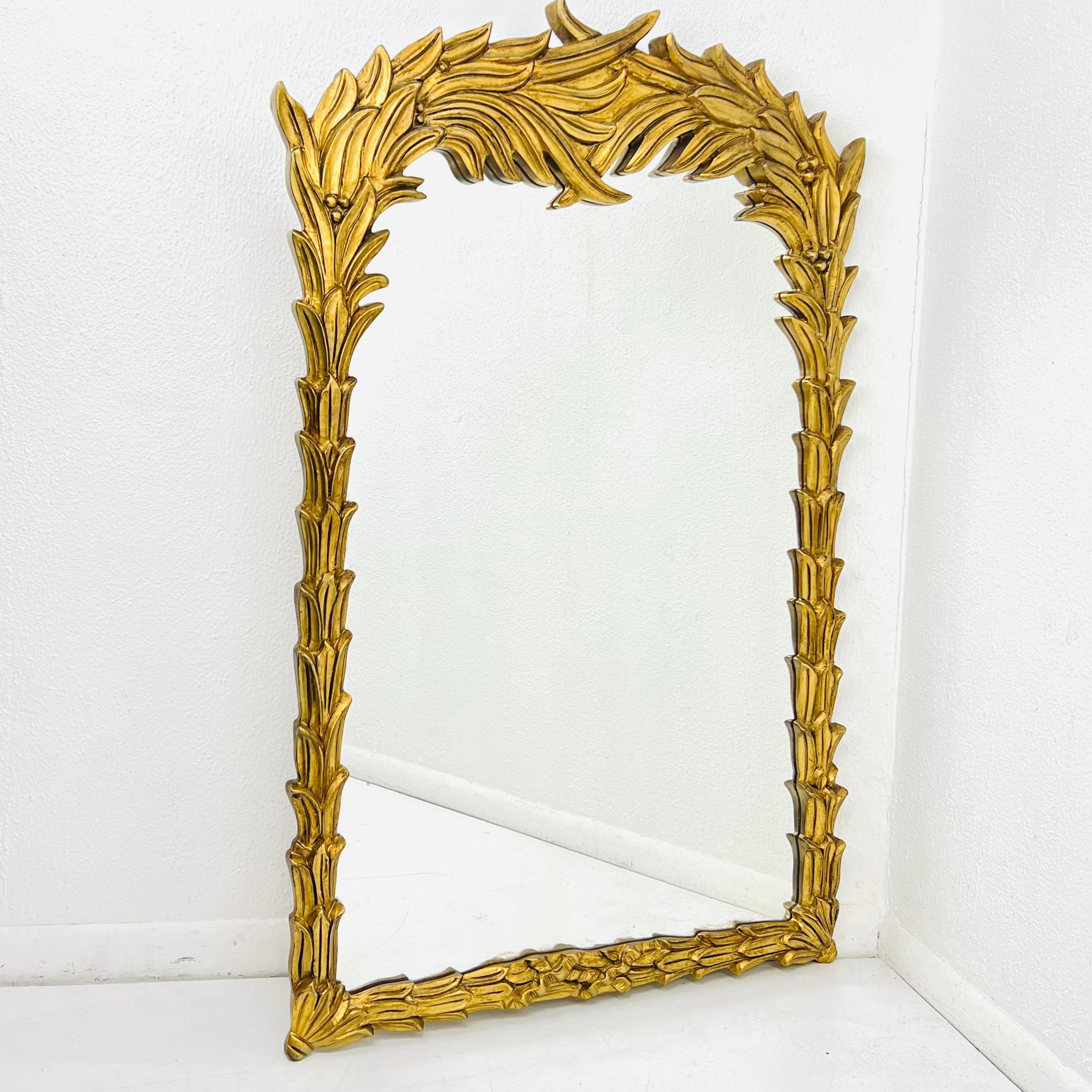 Sculptural palm leaf wall mirror in the manner of modernist designer Serge Roche. Gilded finish accents the gorgeous details in the sculptural palm fronds surrounding the mirror. Very good vintage condition. 32