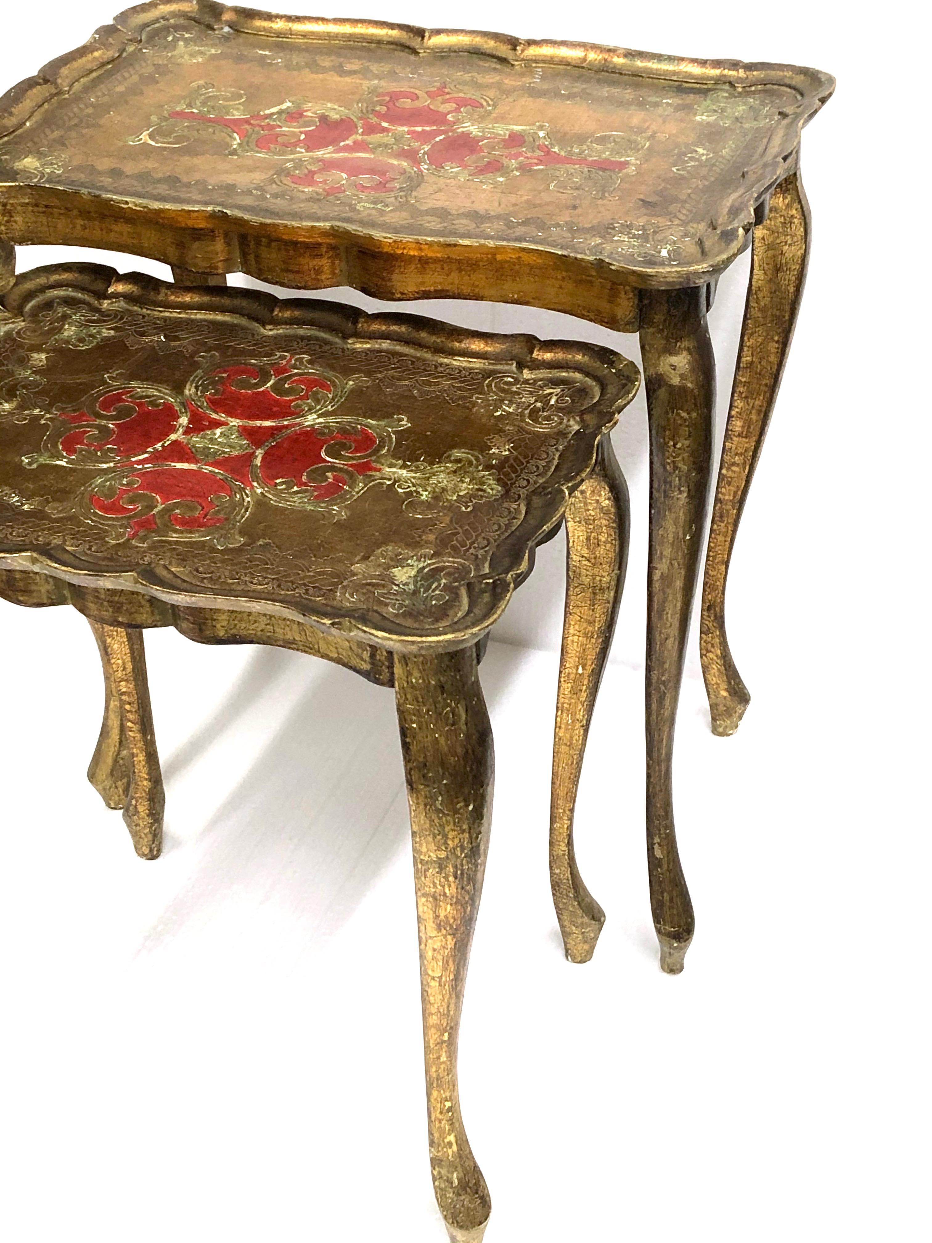 Beautiful Set of two gilded tole nesting tables Hollywood Regency style, vintage Italy, 1960s. Nice addition to any room or hall entry. In used condition, with paint lost and nice shabby chic patina. The tall table is approx. 23