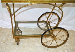 Gilded Wrought Iron Bar Cart on wheels with two levels with glass tops.