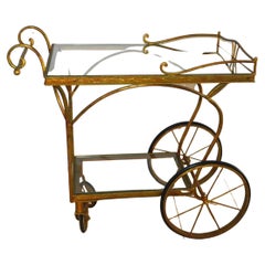 Gilded Wrought Iron Bar Cart on wheels with two levels with glass tops.