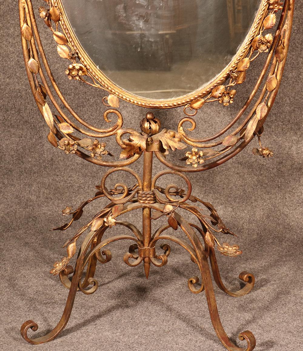 This is an incredible mirror with fine gilded tole metal detailing and is absolutely unique in having two mirrored sides. This is perfect for a wedding shop or for a fine boudoir. The metalwork is incredibly well defined and the flowers and vines